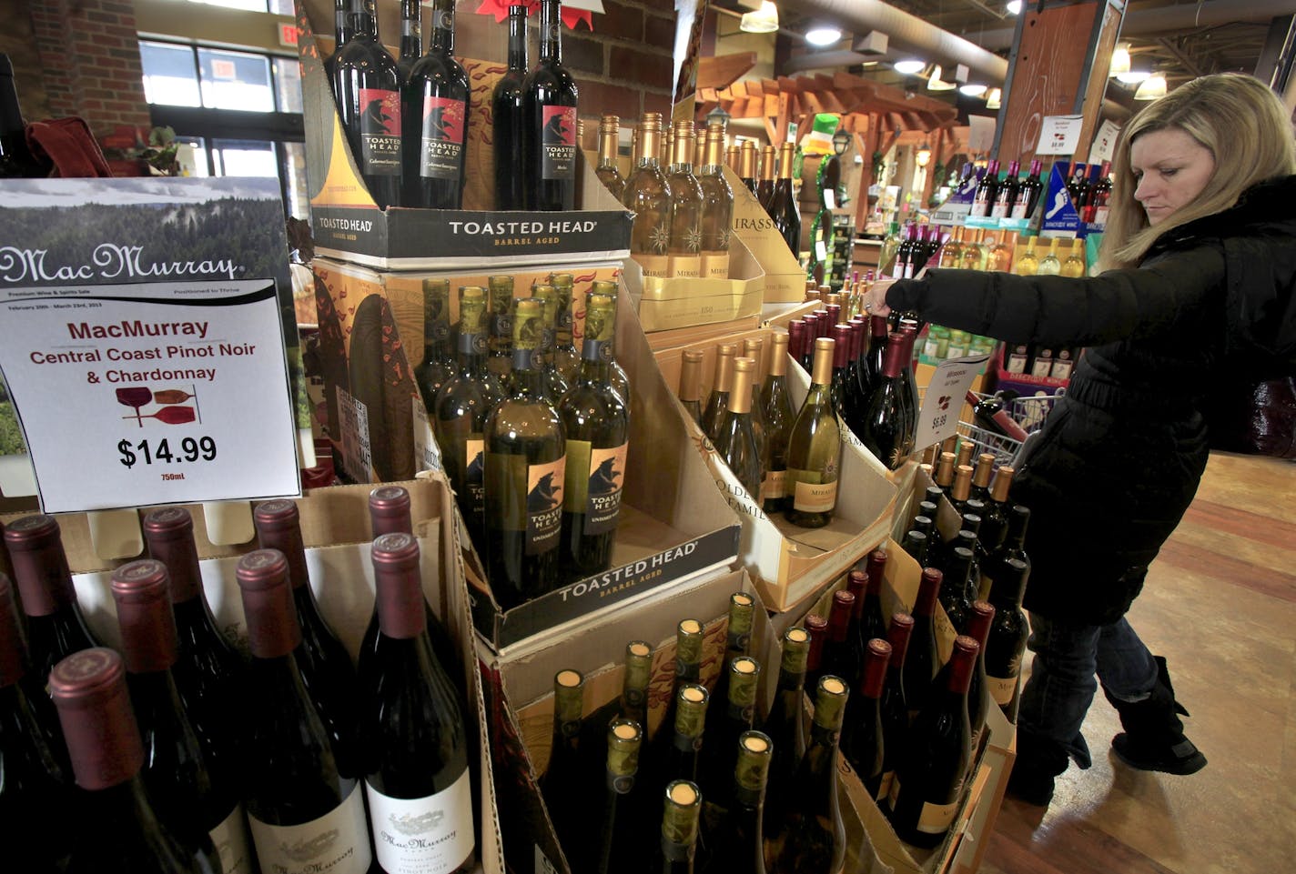 Tami Ross of Lakeville, Mn shopped for wine at the Lakeville Municipal Liquor Store. Lakeville, MN on March 12, 2013. ] JOELKOYAMA&#x201a;&#xc4;&#xa2;joel koyama@startribune.com There are several bills in the House and Senate related to Sunday liquor sales, including one authored by Rep. Pat Garofalo of district 58B/Farmington which asks that Sunday liquor sales be allowed only on Superbowl Sunday 2014. With the Minnesota public generally in favor of Sunday liquor sales and liquor store owners a