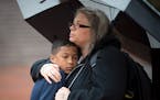 10-year old Taye was embraced by his mother, Susan Montgomery, outside of the Government Center Thursday night. ] Aaron Lavinsky � aaron.lavinsky@st