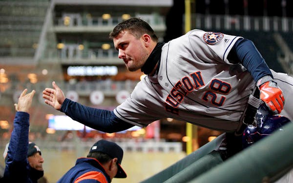 Houston Astros J.D. Davis (28) is congratulated by the dugout after hitting an RBI-single against the Minnesota Twins in the sixth inning of a basebal