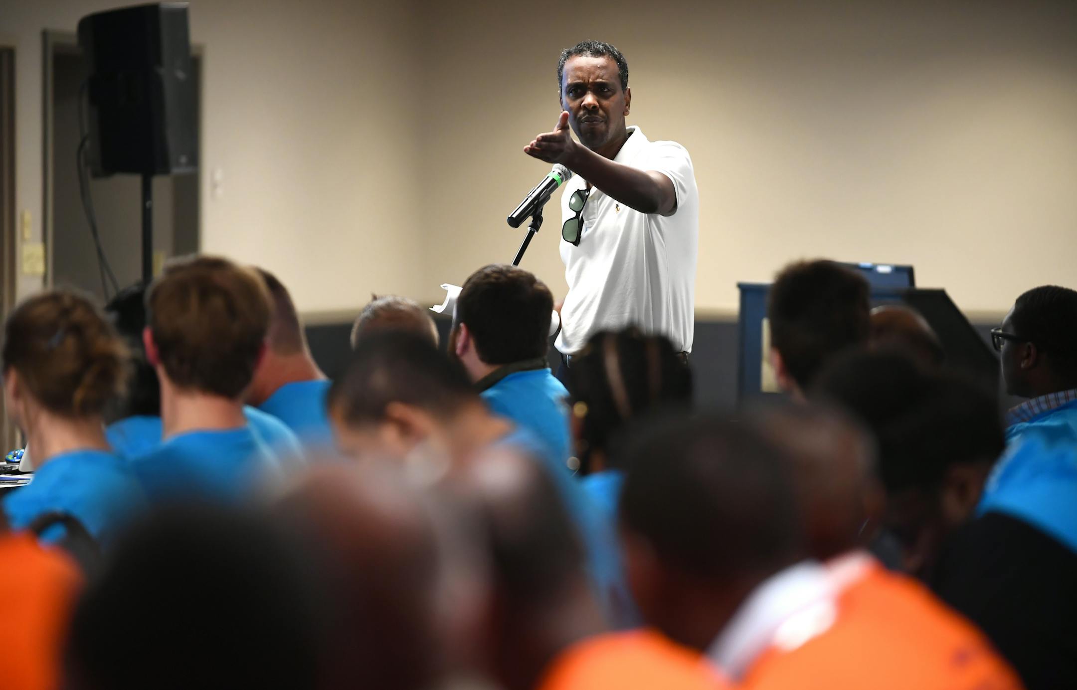 Ward 6 city councilman Abdi Warsame spoke in support of taxi drivers, many of of which come from his community, during a MAC public hearing Wednesday night. ] (AARON LAVINSKY/STAR TRIBUNE) aaron.lavinsky@startribune.com In response to the explosion of transportation options to ferry airport passengers, such as Uber and Lyft, the Metropolitan Airports Commission is considering a big change in the way it regulates taxicabs. The change would reduce a $3,350 one-time fee to $100 now charged to cabbi