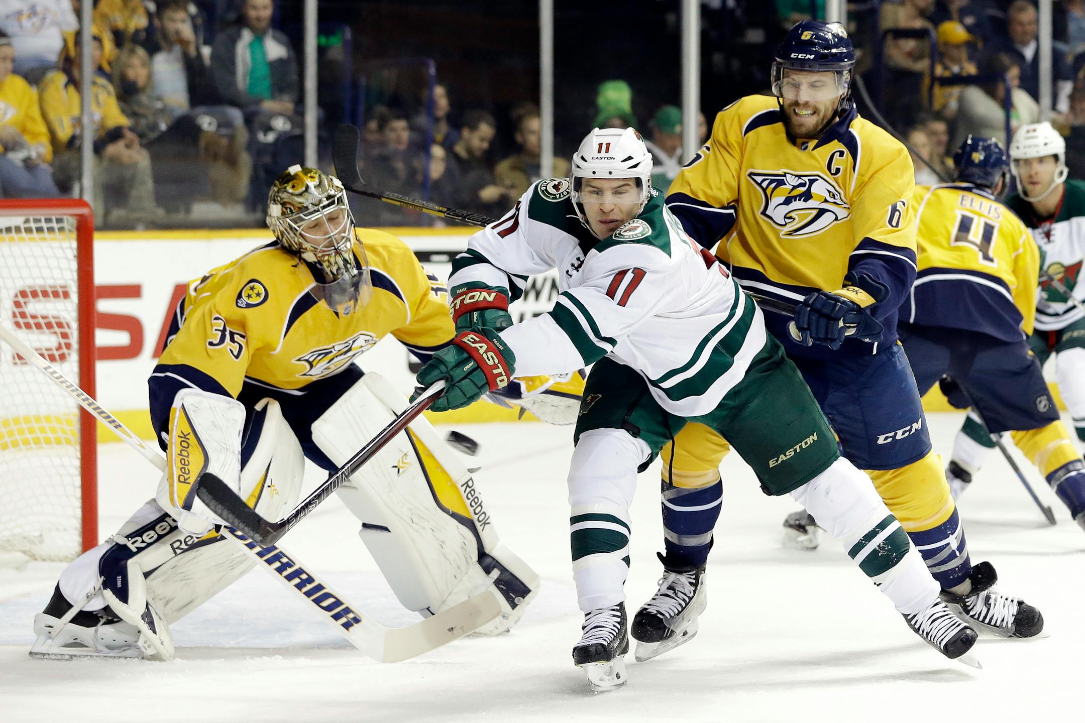 Minnesota Wild left wing Zach Parise (11) tries to deflect a shot as Nashville Predators goalie Pekka Rinne (35), of Finland, and Shea Weber (6) defend in the first period of an NHL hockey game Tuesday, March 17, 2015, in Nashville, Tenn. (AP Photo/Mark Humphrey)
