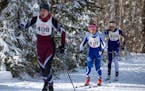 Margo Nightingale from Mounds Park Academy in St. Paul prepared to pass Greta Hansen from Math &amp; Science Academy during the classic Nordic ski rac