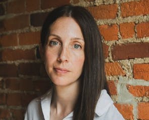 photo of author Liz Moore in front of a brick wall