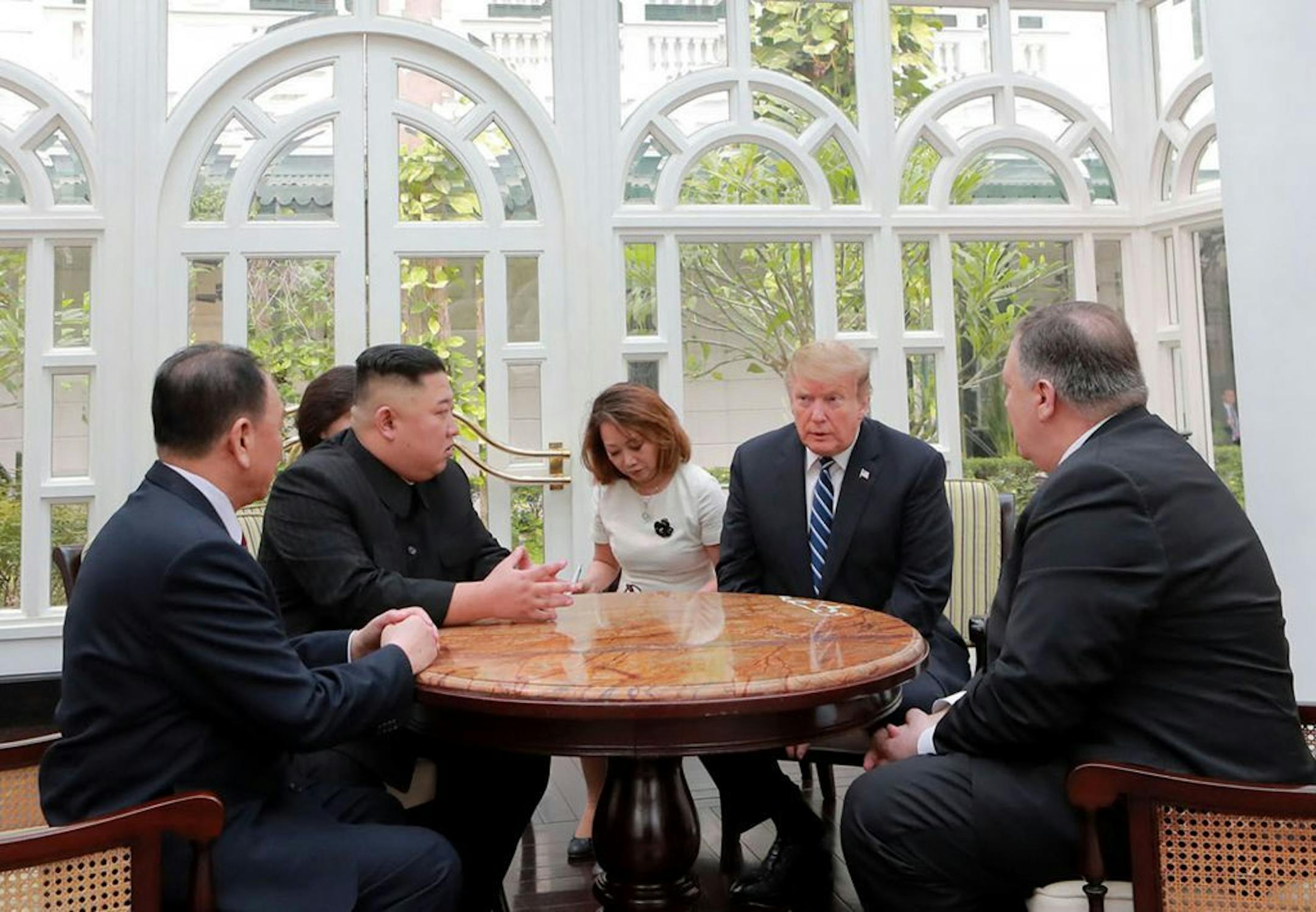 ALTERNATE CROP OF KNS802 - In this Thursday, Feb. 28, 2019, photo provided Friday, March 1, 2019, by the North Korean government, U.S. President Donald Trump, second from right, and North Korean leader Kim Jong Un, second from left, talk at a hotel in Hanoi, Vietnam. U.S. Sec. of State Mike Pompeo is at right. Kim Yong Chol, a North Korean senior ruling party official and former intelligence chief is at left. The content of this image is as provided and cannot be independently verified.
