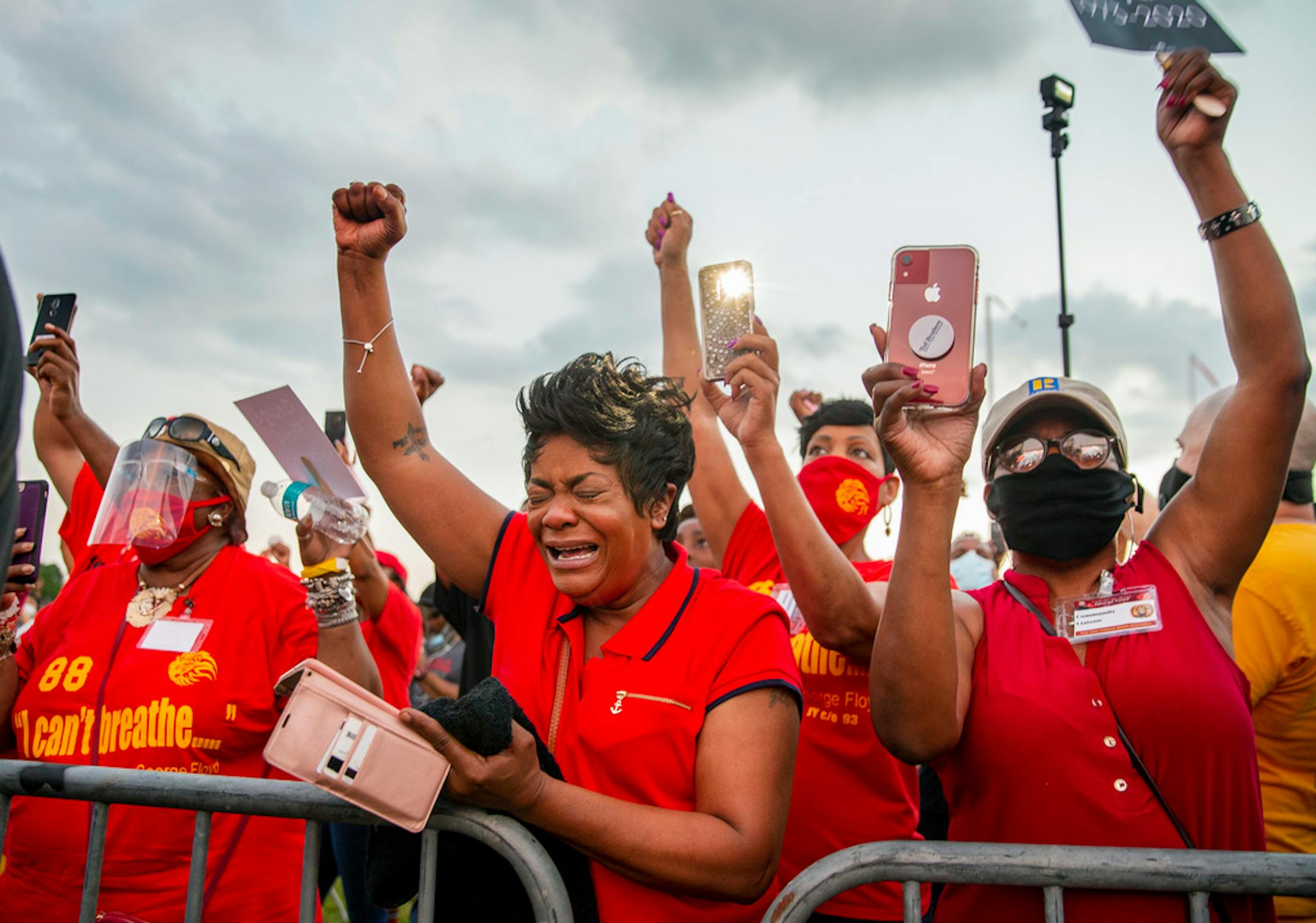 Cecil Munoz, center, and others attend a candlelight vigil honoring George Floyd at Jack Yates High School in Houston on Monday, June 8, 2020. Floyd died May 25 after being restrained by police in Minneapolis. (Ricardo B. Brazziell/Austin American-Statesman via AP)