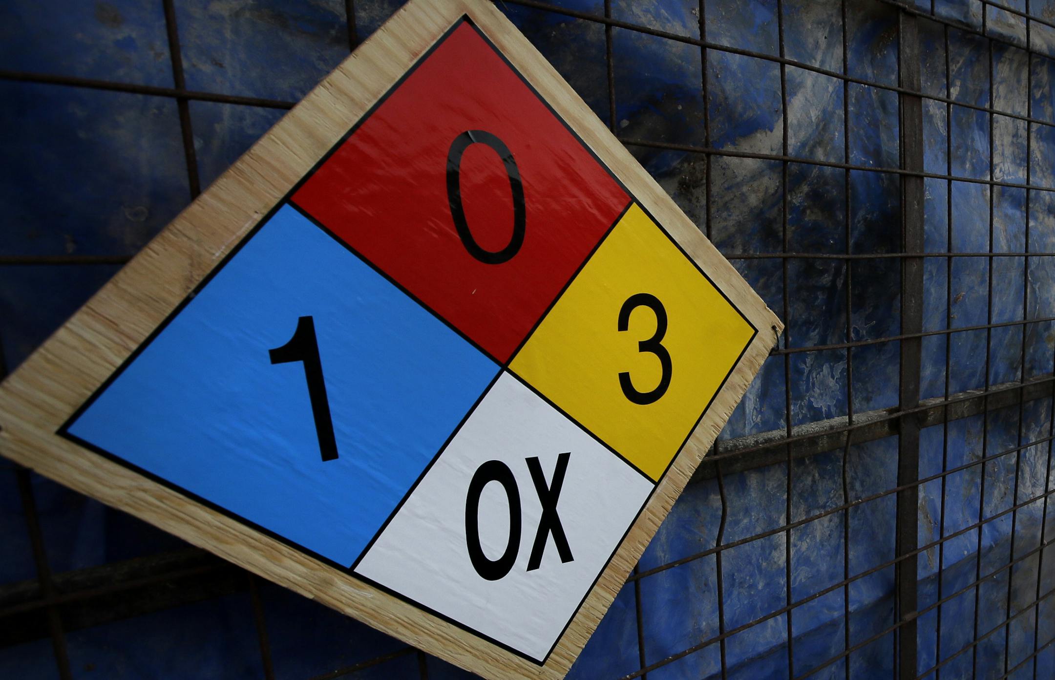 A chemical safety placard warns of a product kept inside the facility.