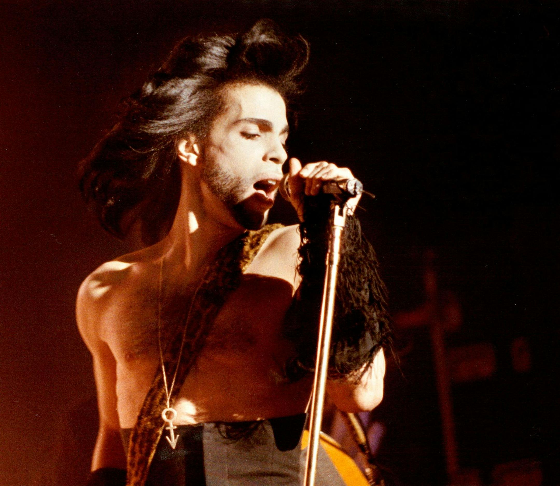 In this May 2, 1990 photo Prince performs a benefit concert for the family of Charles (Big Chick) Huntsberry in Minneapolis. Prince, widely acclaimed as one of the most inventive and influential musicians of his era with hits including "Little Red Corvette," ''Let's Go Crazy" and "When Doves Cry," was found dead at his home on Thursday, April 21, 2016 in suburban Minneapolis, according to his publicist. He was 57. (David Brewster/Star Tribune via AP) MANDATORY CREDIT; ST. PAUL PIONEER PRESS OUT;