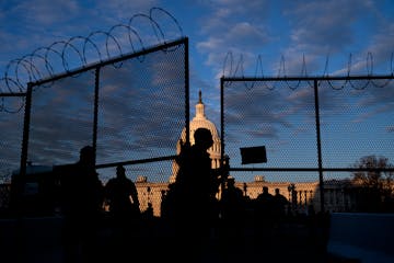 A member of the National Guard closed a section of security fencing outside the Capitol in Washington, on Saturday, Jan. 16, 2021. Federal officials h