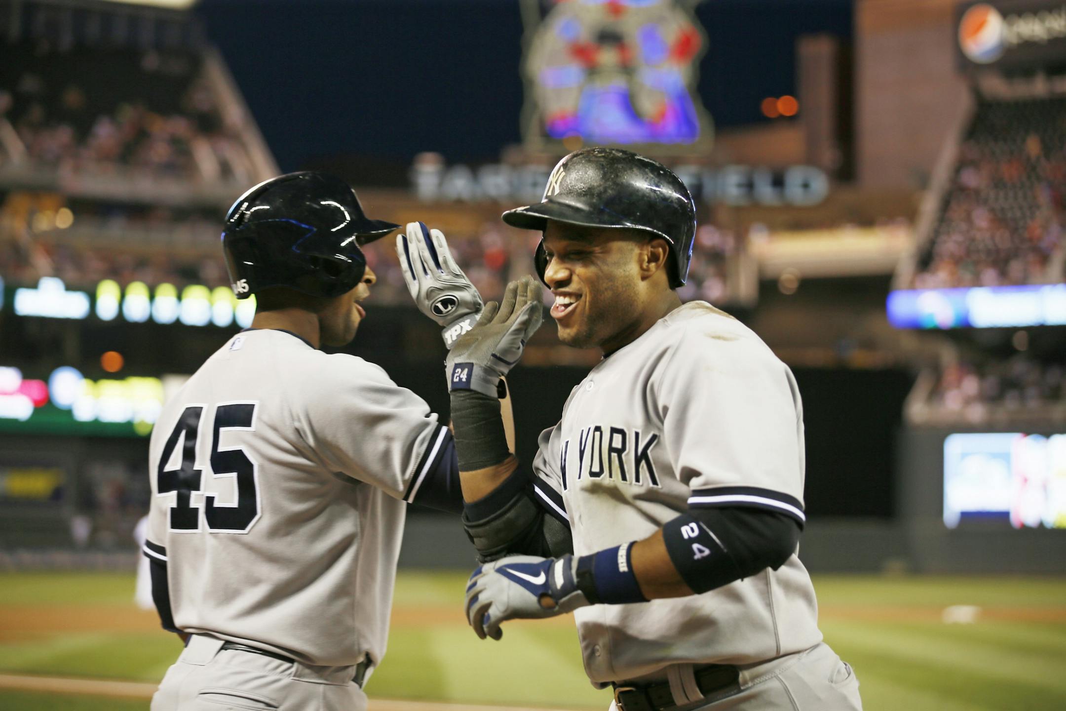 Yankees Robinson Cano celebrated his 3 run homer in the seventh inning with teammate Zoilo Almonte during MLB action between the Minnesota Twins and New York Yankees at Target Field on Tuesday night July, 2, 2013. Minneapolis, MN .