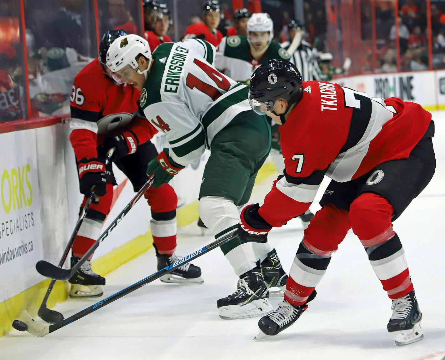 Ottawa Senators left wing Brady Tkachuk (7) takes the puck away from Minnesota Wild center Joel Eriksson Ek (14) during second period NHL hockey action in Ottawa, Monday, Oct. 14, 2019. (Fred Chartrand/The Canadian Press via AP)