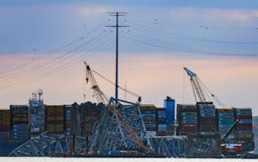 Workers start to remove a section of the collapsed Francis Scott Key Bridge, Sunday, March 31, 2024, in Baltimore. (AP Photo/Julia Nikhinson)