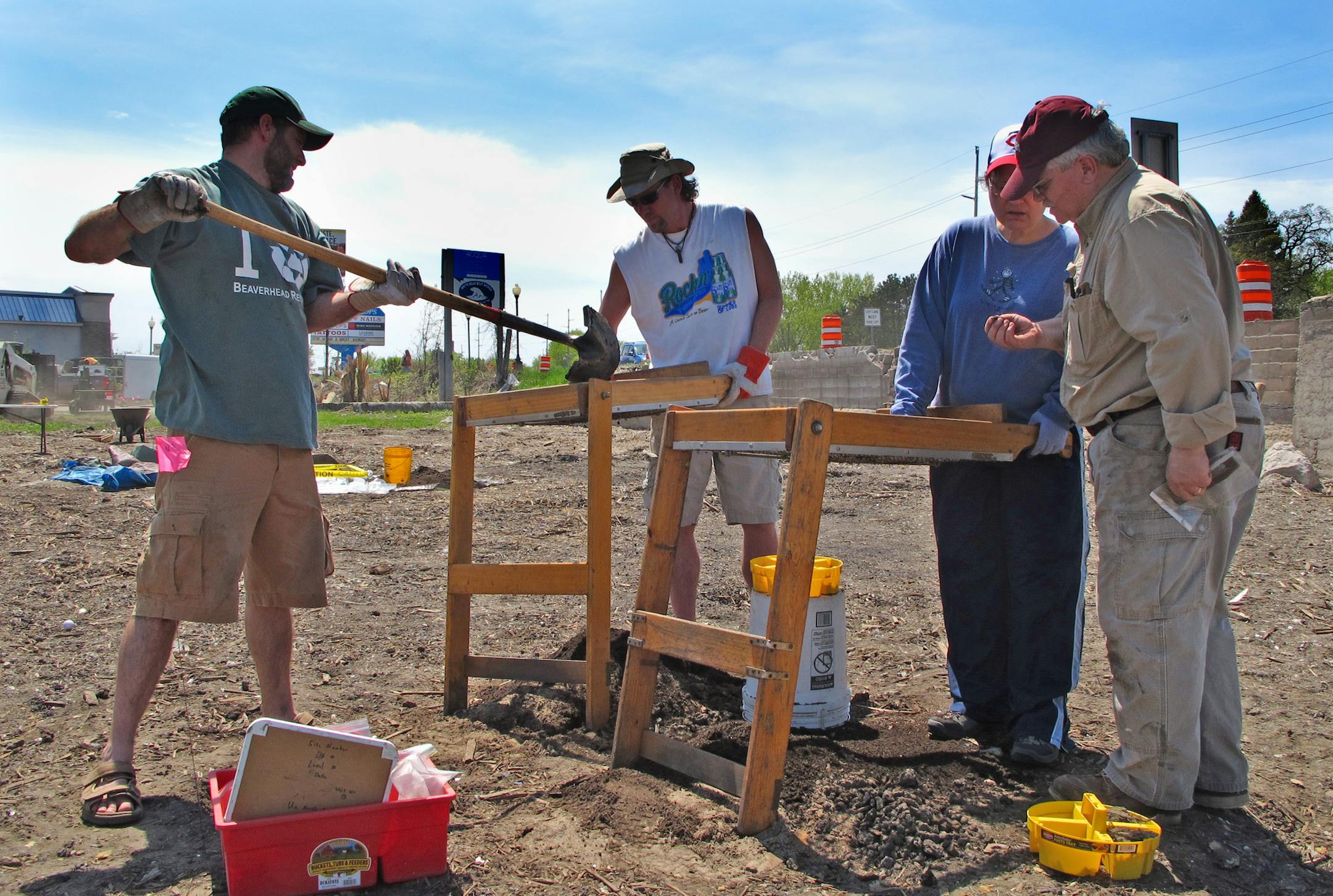 ARCH1: From the left, volunteer diggers John Hargroves, Chet Kuhn and Debbie Bartlett joined archaeologist Dave Radford Thursday afternoon at the Johnson Boat Works site on the shore of White Bear Lake. The site will be excavated though the weekend by volunteers before being closed down as construction begins on a new mixed-used development called BoatWorks (one word) Commons that includes apartments, retails, a restaurant and parking ramps. Photo: Jim Anderson/Star Tribune