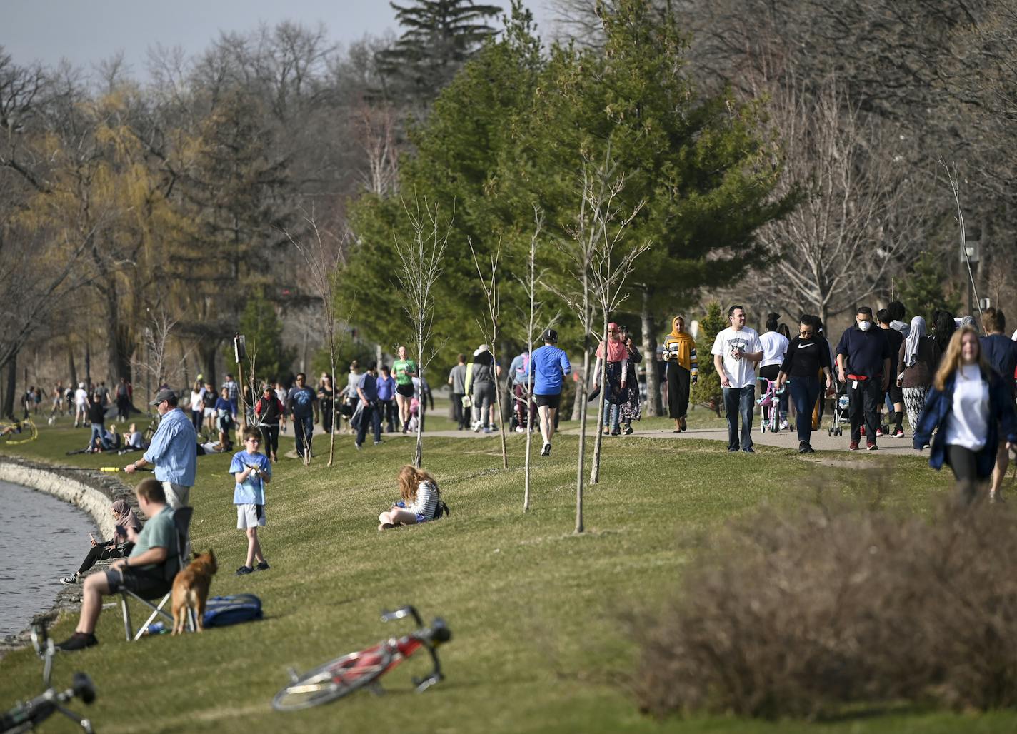 Hundreds of pedestrians and cyclists spent the afternoon at Bde Maka Ska Wednesday. ] aaron.lavinsky@startribune.com Minneapolis' parks have become a source of respite for anyone needing peace of mind during Gov. Walz's stay-at-home order to control the coronavirus outbreak. Enter the Minneapolis Park Board and Superintendent Al Bangoura. We take an inside look at how the board is making decisions to open or close parkways, how they're monitoring social distancing and why they're so keen on keep