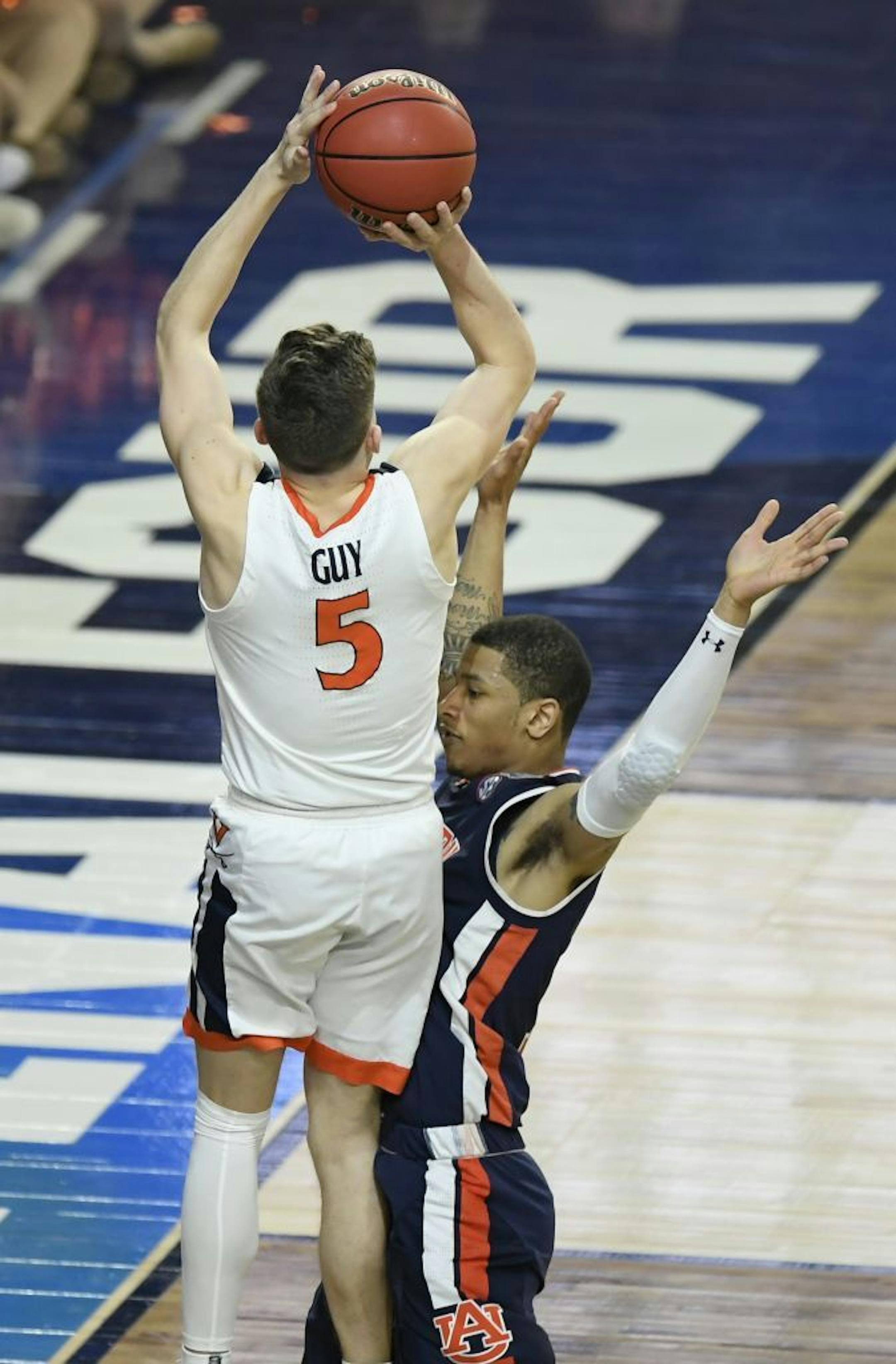 Virginia Cavaliers guard Kyle Guy (5) got fouled by Auburn guard Samir Doughty during the last seconds of the game. Virginia won 63-62.