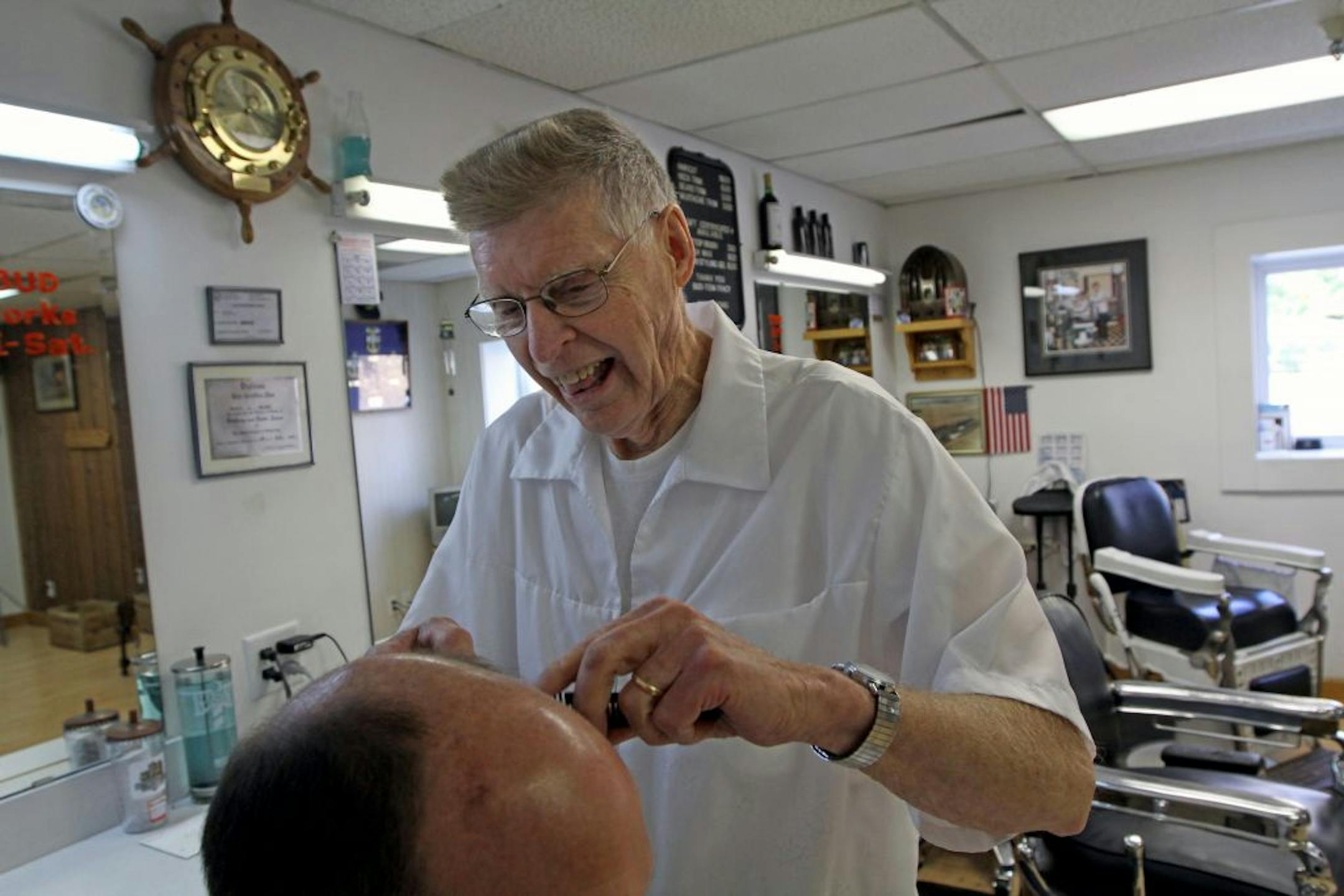 Barber Bud Mohn trimmed a customers hair at TR's Barber shop in downtown Lakeville.