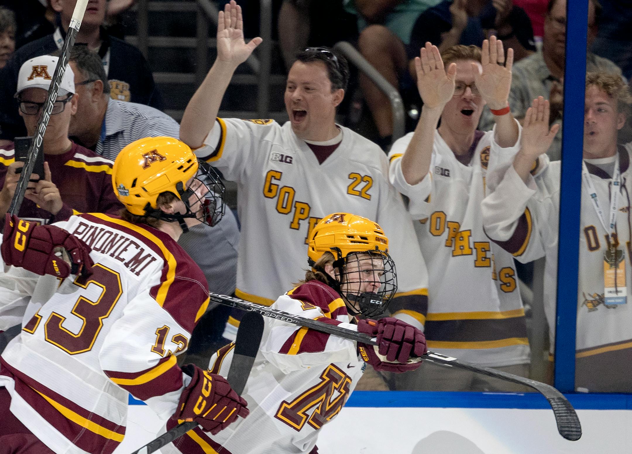 John Mittelstadt (19) of Minnesota celebrates with teammates after scoring in the first period.