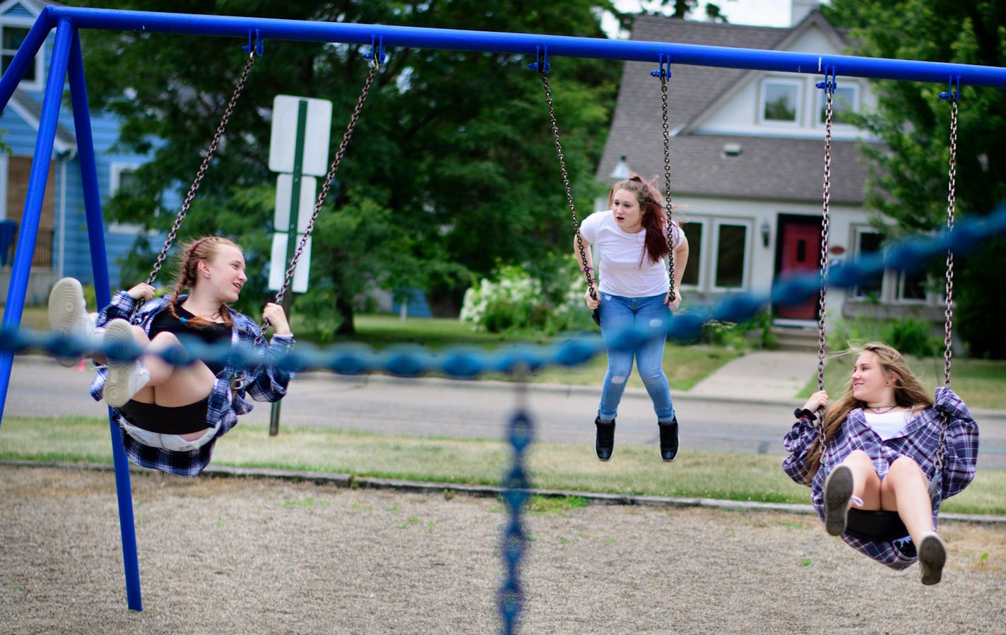 Chloe Bennett, 14, left, and her friends Kenzie and Haley Klun, both 15, swung on swings near their homes. ] GLEN STUBBE * gstubbe@startribune.com Thursday, June 30, 2016 Chloe Bennett, 14 and her friend Haley Klun, 15 are hanging out at their usual time to explore the woods and take pictures near Chloe's home in Hopkins. Chloe, 14, waited too long to find a summer job so she said she's often bored. "It's hard to find stuff to do," she said. "The days are really long without school.". For parent