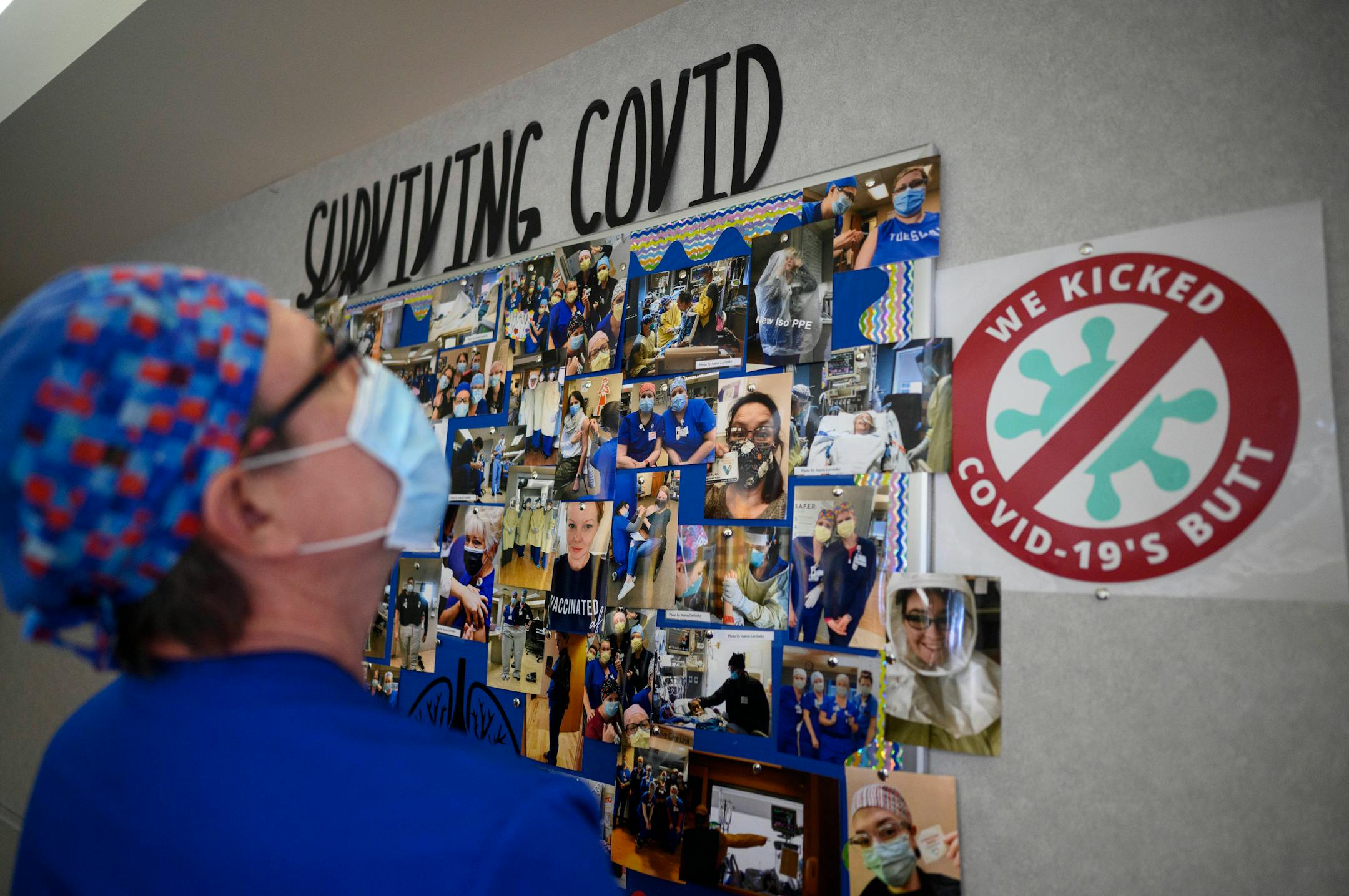 Joe Walker, a critical care nurse with North Memorial Health Hospital, looked over a photo collage commemorating a year of COVID-19 in North Memorial's South 7 ICU on Wednesday.