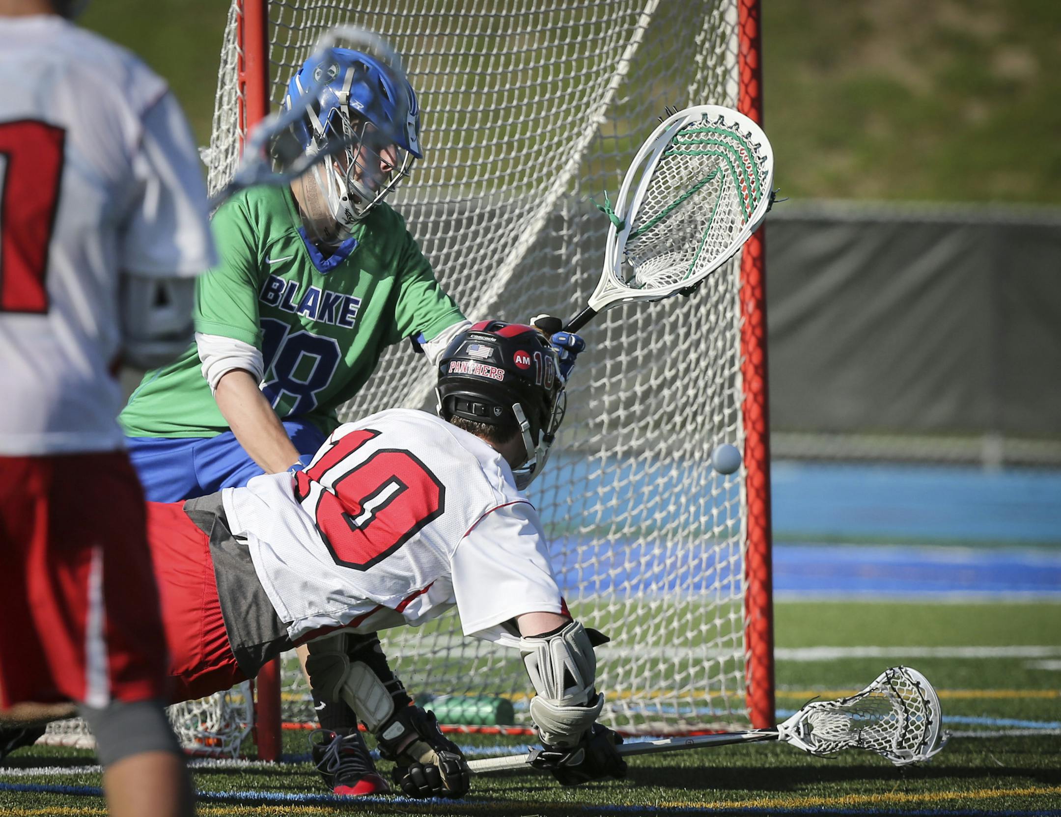 Lakeville North's Roman Rohrbach score on Blake goalie Nick Washuta in the second period at Minnetonka High School in Minnetonka, Minn., on Tuesday, June 9, 2015. ] RENEE JONES SCHNEIDER • reneejones@startribune.com Lakeville North verses The Blake School in the Lacrosse quarterfinals match.