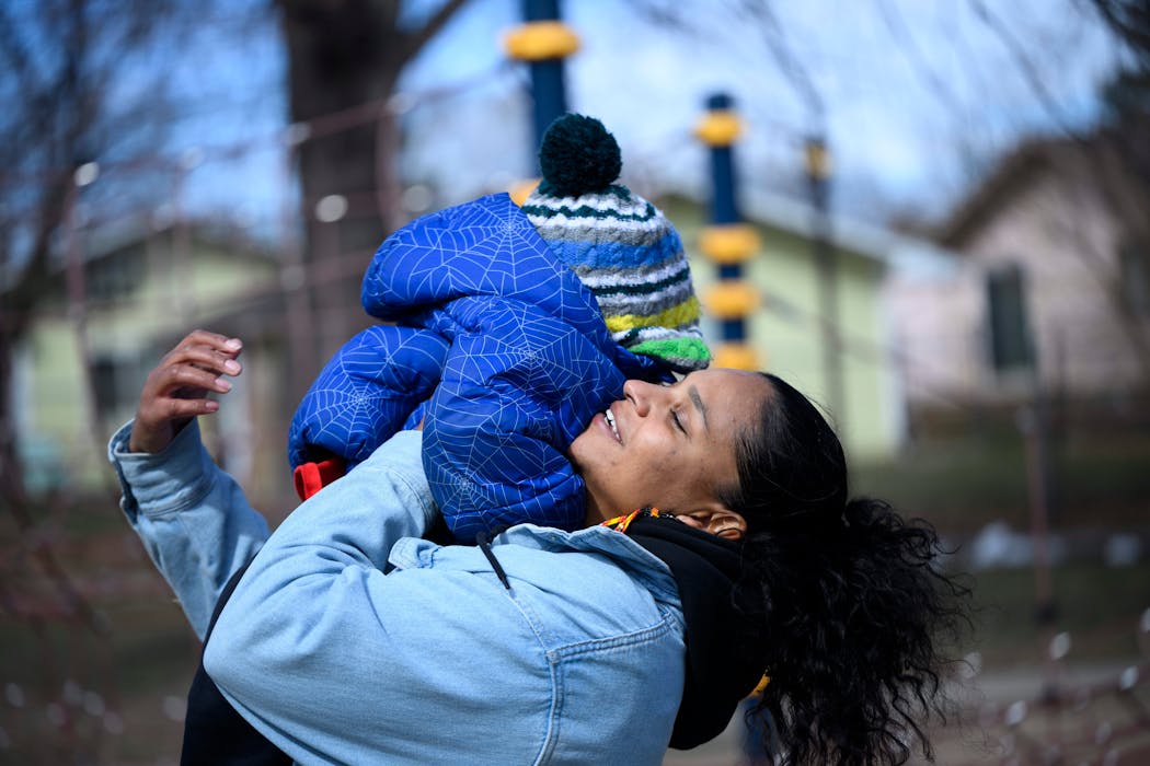 Mercedes Yarbrough lifted up her son Meir, 2, after the two played tag at Central Village Park Wednesday in St. Paul. More cities and nonprofits across the country are trying guaranteed income programs, where they give monthly checks to families with no strings attached. State leaders are now considering a pilot program in Minnesota. Mercedes' family gets $500 a month through St. Paul's program, and it's had a big impact on their lives.