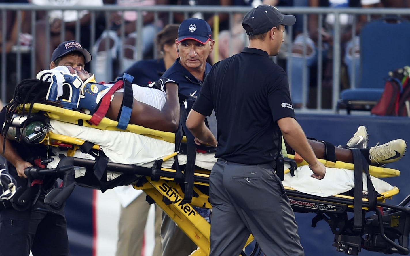 Central Florida defensive back Aaron Robinson is taken off the field after being injured on the opening kickoff in the team's NCAA college football game against Connecticut on Thursday, Aug. 30, 2018, in East Hartford, Conn. (AP Photo/Stephen Dunn)