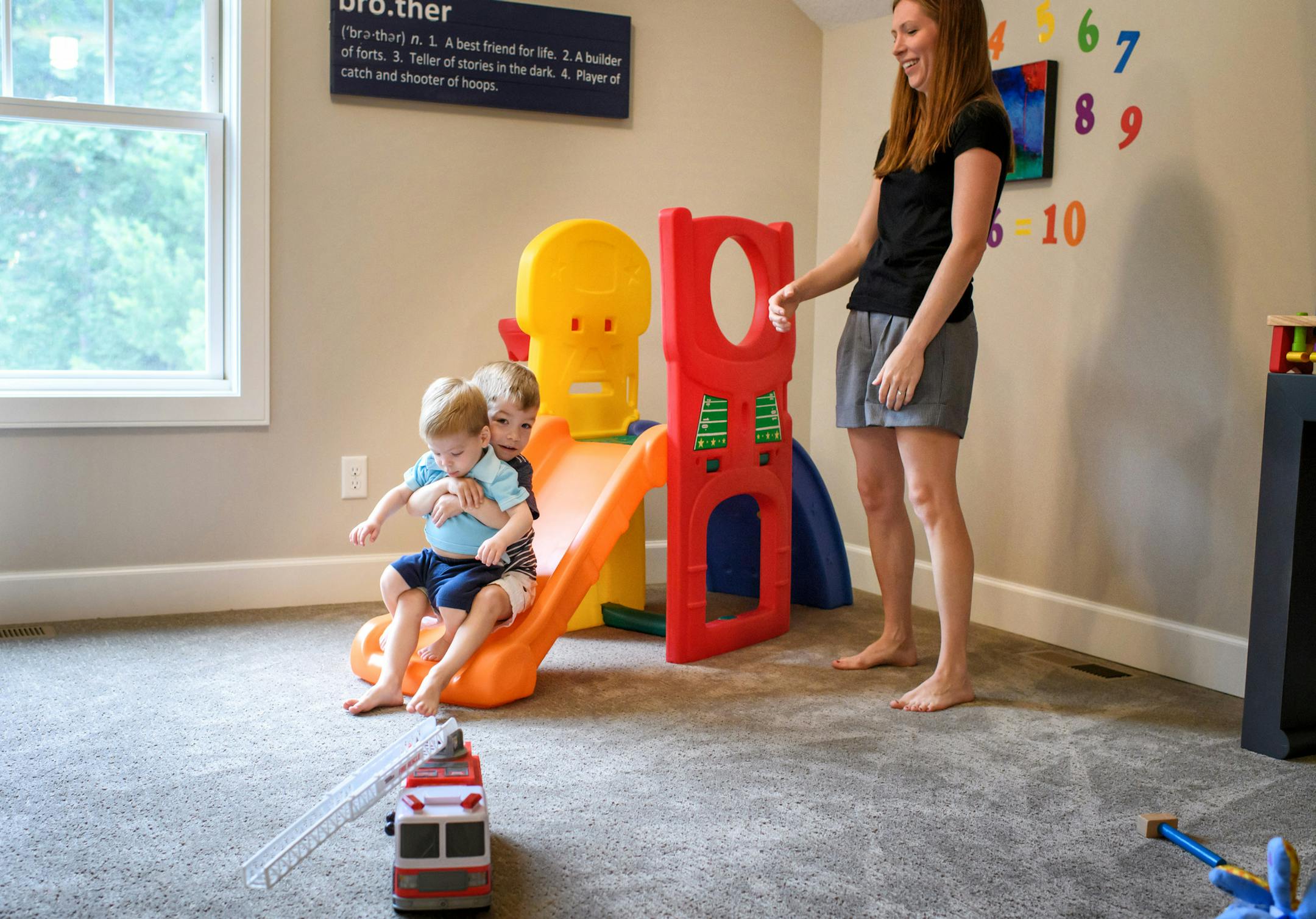 Jackie's daughter Rachel with her two children play in the playroom. ] GLEN STUBBE * gstubbe@startribune.com Wednesday, July 13, 2016 266246 Upsizing for grandkids. Empty-nester Jackie Chase built a bigger, kid-friendly house in Mendota Heights as a magnet for her grandkids.EDS, family did not wants kids names used.