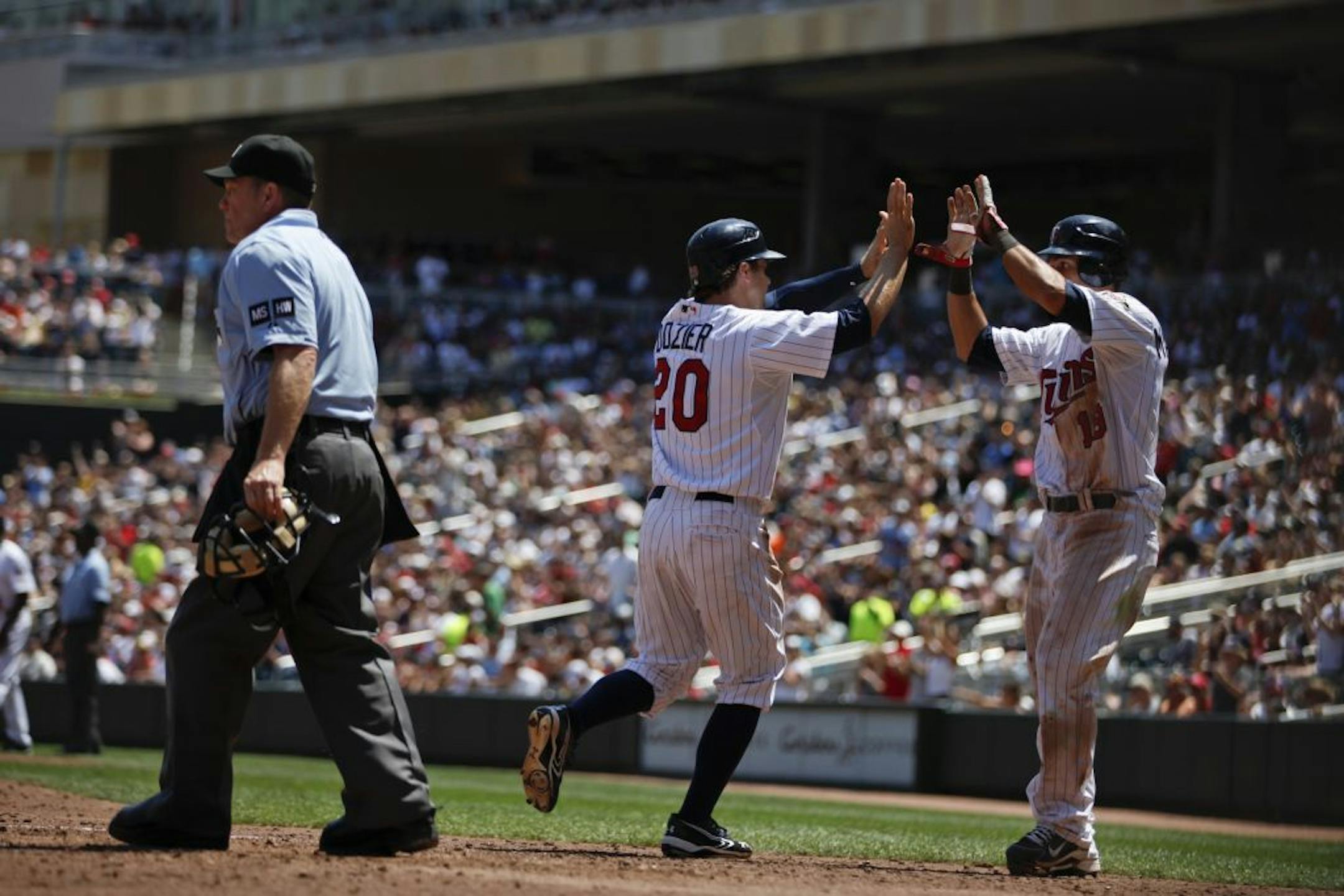 During the Kansas City Royals vs. Minnesota Twins home game (game one), short stop Brian Dozier celebrates his run with catcher Ryan Doumit in the fifth inning at Target Field in Minneapolis, Minn. on Saturday, June 30, 2012. The Twins won 7-2.