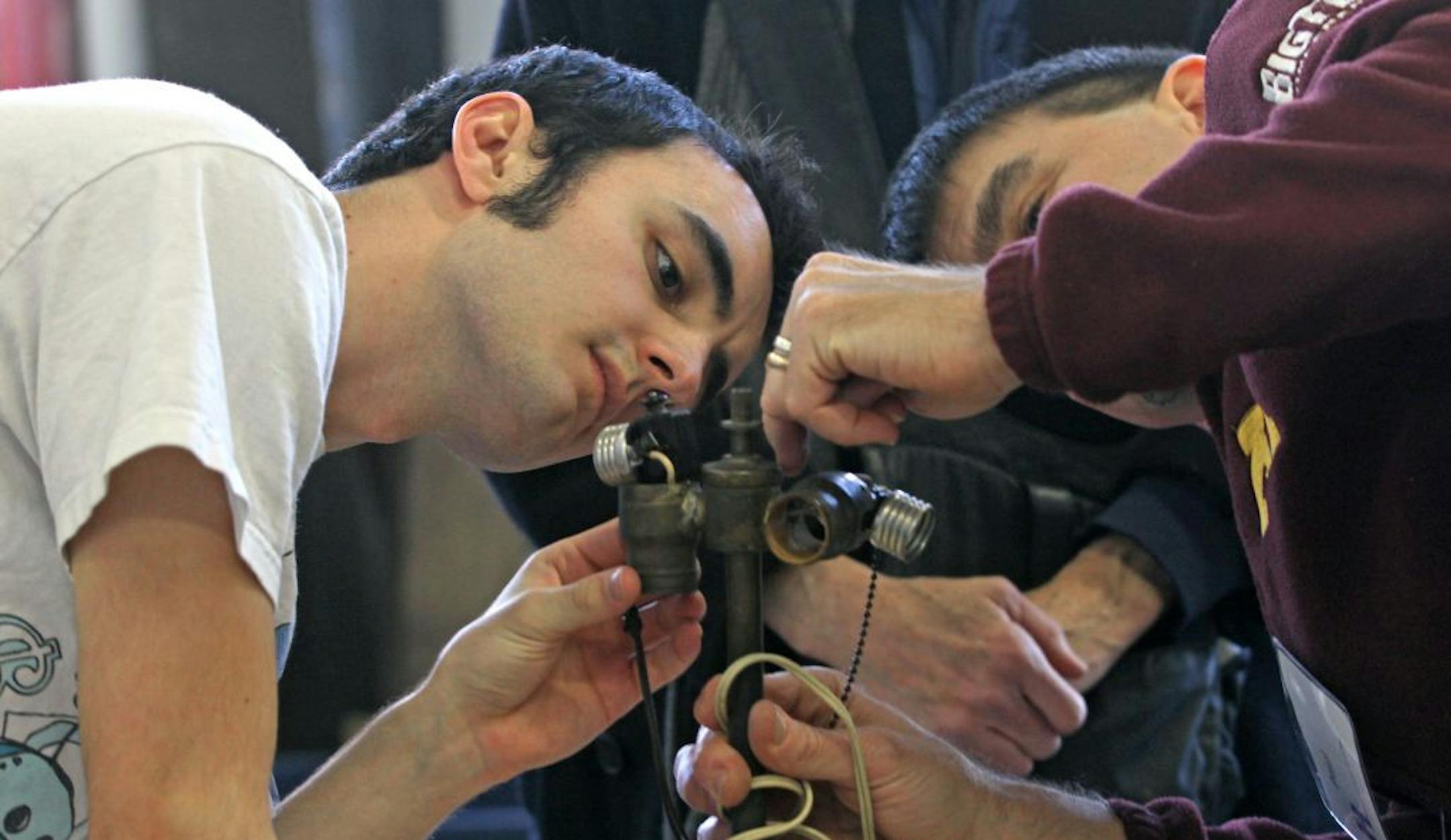 Jimmy Lynch and Paul Dingels fixed the lamp of Molly Ross of Edina during the Hennepin County Fix-It Clinic.