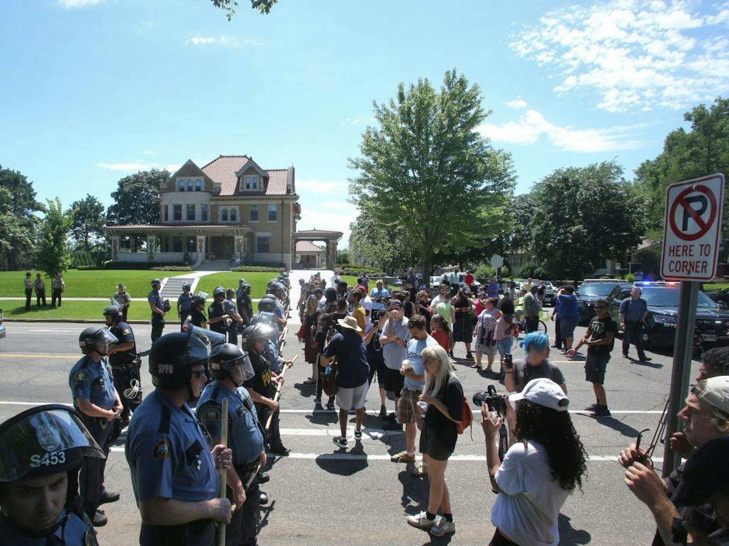 Protesters and St. Paul police officers faced off at Oxford and Summit Avenue in St. Paul following arrests outside the governor's residence.