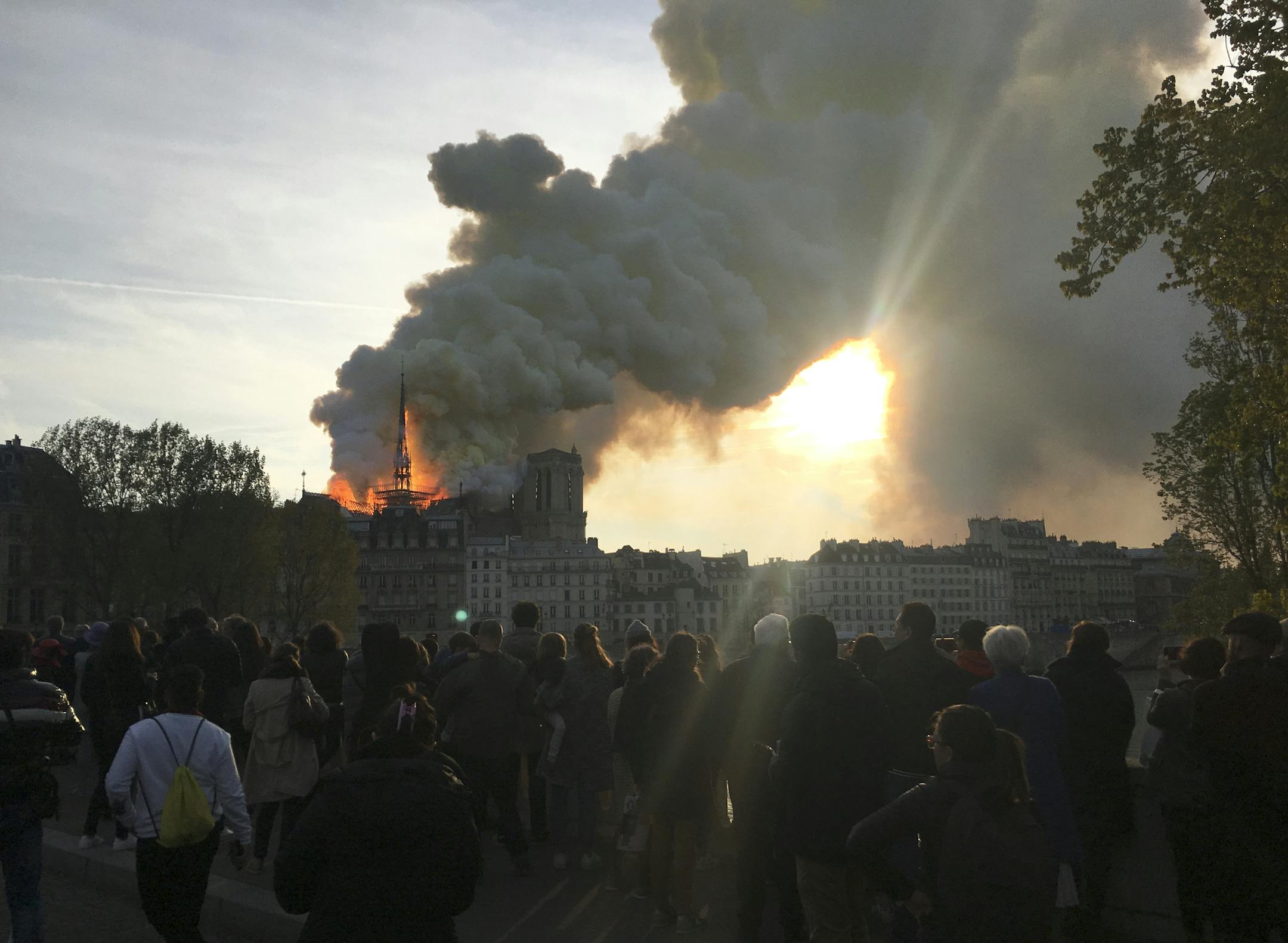 This photo taken on Monday April 15, 2019 shows Notre Dame cathedral burning in Paris. Firefighters declared success Tuesday April 16, 2019 morning in an over 12-hour battle to extinguish an inferno engulfing Paris' iconic Notre Dame cathedral that claimed its spire and roof, but spared its bell towers. (AP Photo/Oleg Cetinic)