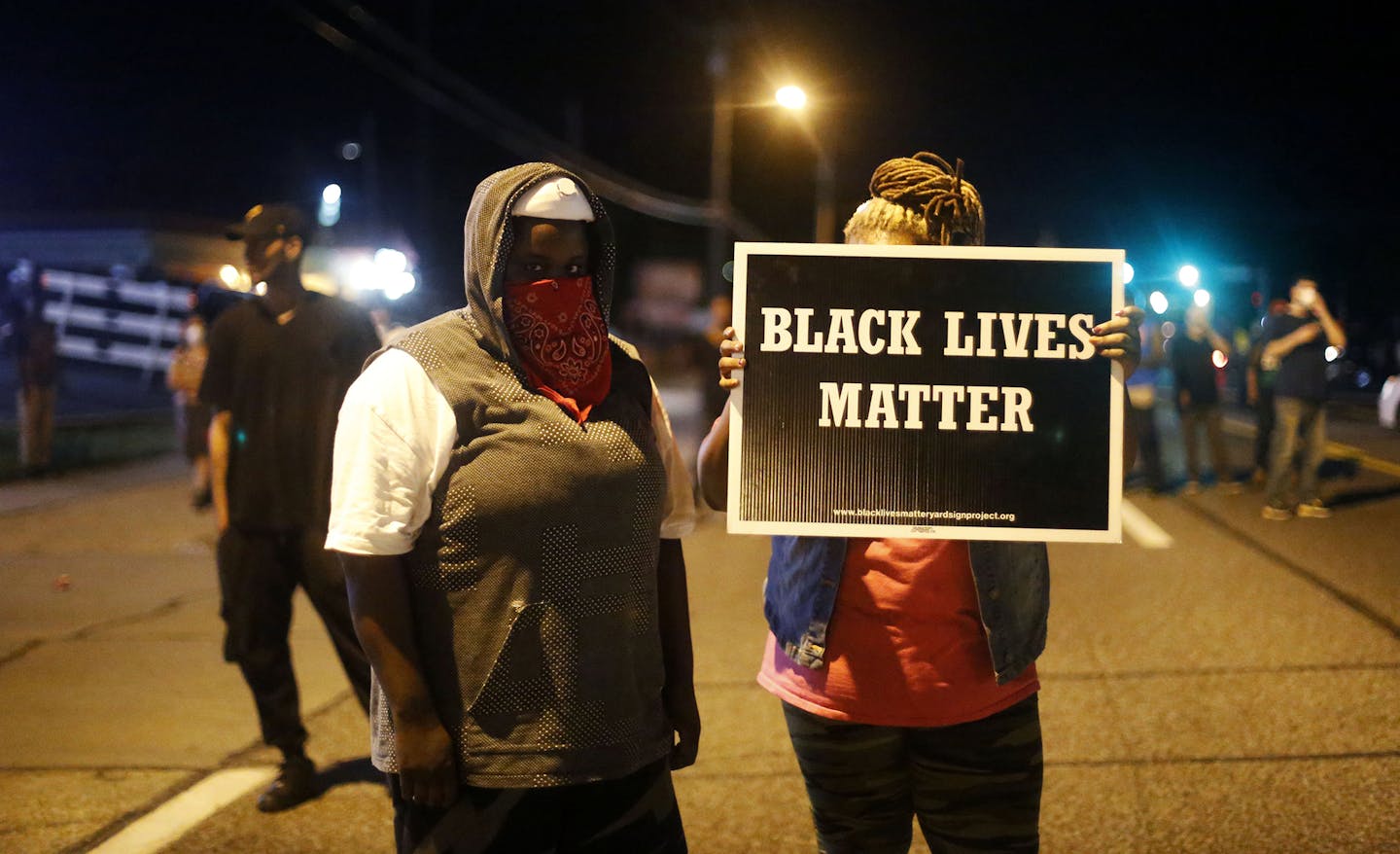 A woman holds up a sign which reads "Black Lives Matter" in Ferguson, Mo., on Monday, Aug. 10, 2015. A state of emergency was declared for Ferguson and the rest of St. Louis County Monday following a gun battle between police and protesters Sunday night on the anniversary of Michael Brown's death. (Jim Vondruska/Xinhua/Sipa USA/TNS) ORG XMIT: 1172155 ORG XMIT: MIN1508110928440819