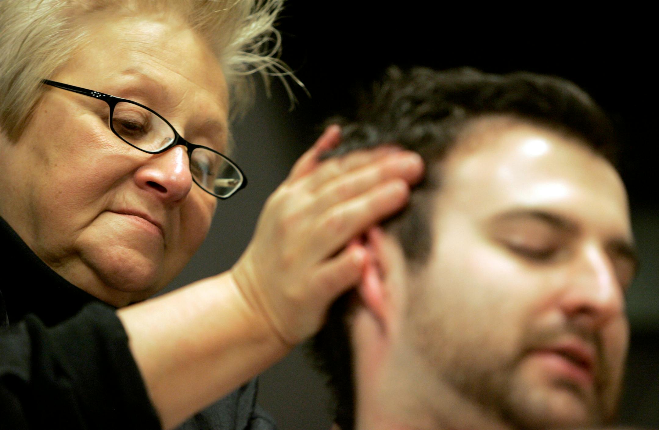 "Mother"Mary Lundberg gave Brett Dicus a massage at Xcel Energy Center on Sunday afternoon. Dicus works as an audio engineer on the Bruce Springsteen and The E Street Band tour.