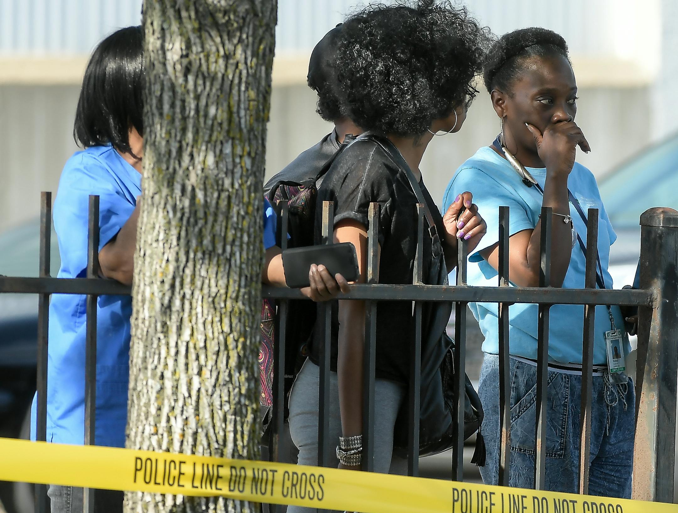 A crowd gathered behind the police tape at the scene of a homicide on the 600 block of Broadway Avenue West in Minneapolis Friday. ] AARON LAVINSKY � aaron.lavinsky@startribune.com Minneapolis Police investigate the scene of a homicide in a strip mall on the 600 block of Broadway Avenue West in Minneapolis on Friday, May 12, 2017.