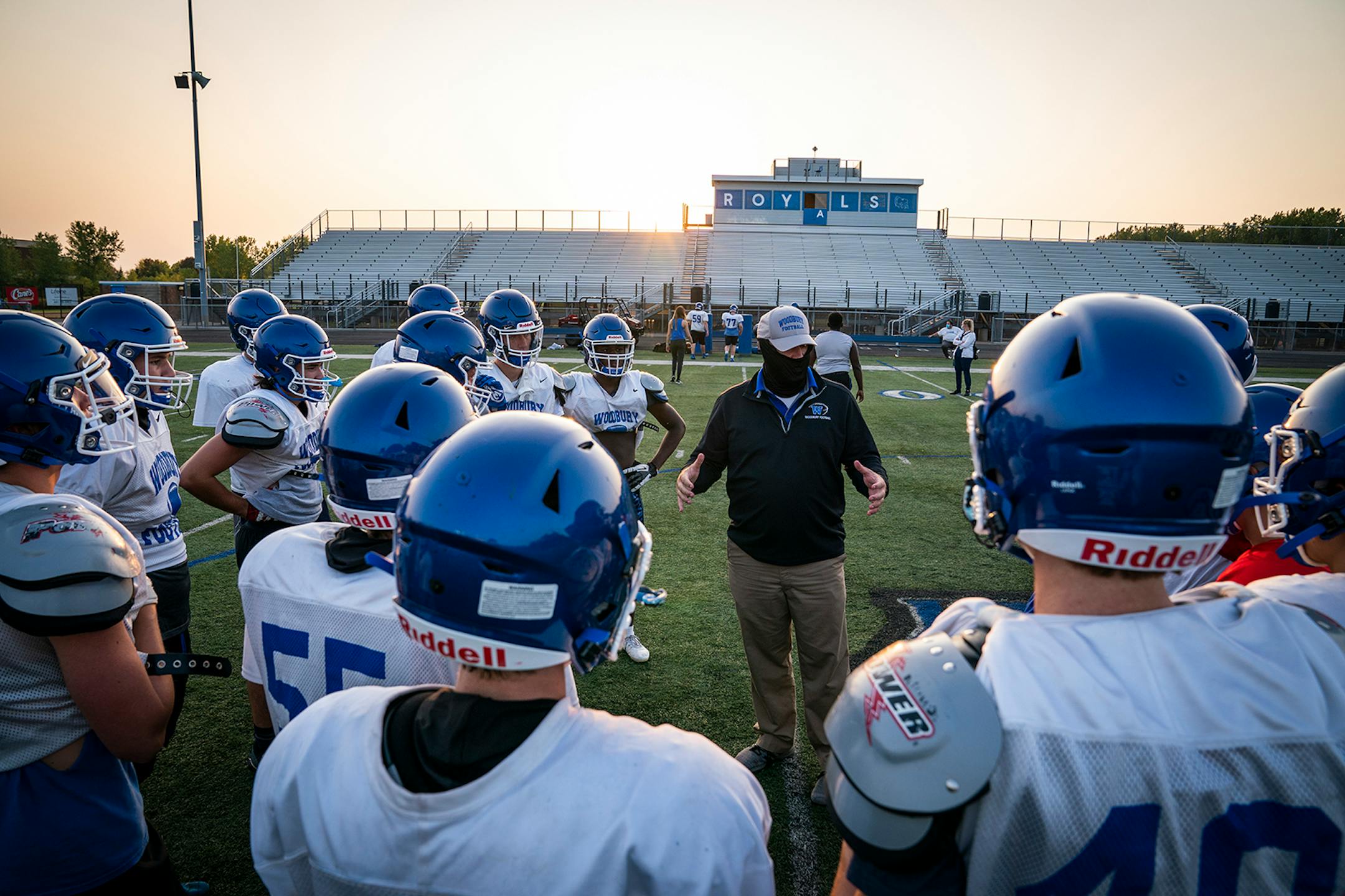 Head coach Andy Hill wore a mask during Woodbury High School football practice.