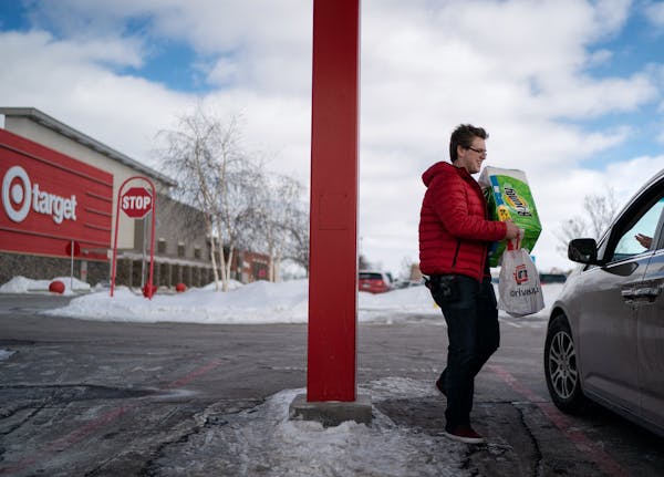 Tristan Conway brought an order from the Apple Valley Target store to the new drive up outside the store. ] GLEN STUBBE &#x2022; glen.stubbe@startribu