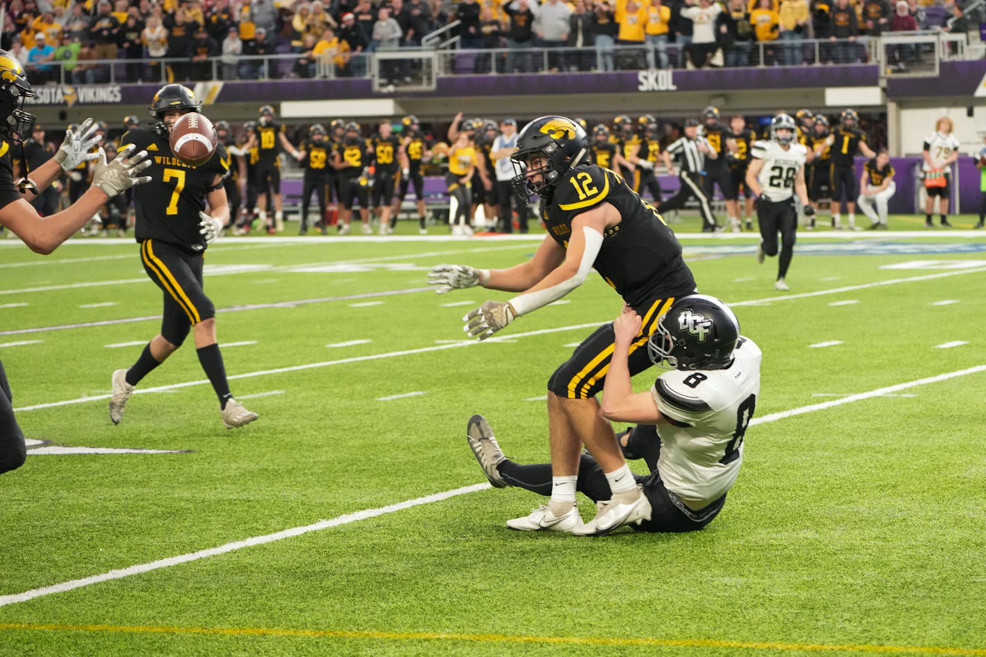 As he's wrapped up by Dilworth-Glyndon-Felton's Brody Friend (8) as time runs out of the game, New London-Spicer's Grant Paffrath (12) pitches the ball back to teammate Brycen Christensen (81) who ran in for the winning touchdown over Dilworth-Glyndon-Felton in the Minnesota High School football Class 3A State Championship at U.S. Bank Stadium in Minneapolis, Minn., on Saturday, Dec. 3, 2022. ] SHARI L. GROSS • shari.gross@startribune.com ORG XMIT: MIN2212041438500061