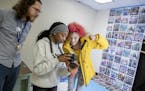 North High School teacher Sam Wilbur, who co-teaches the class with Kenzie O'Keefe, supervised a photo shoot with students, Raelyn Walker, center, and