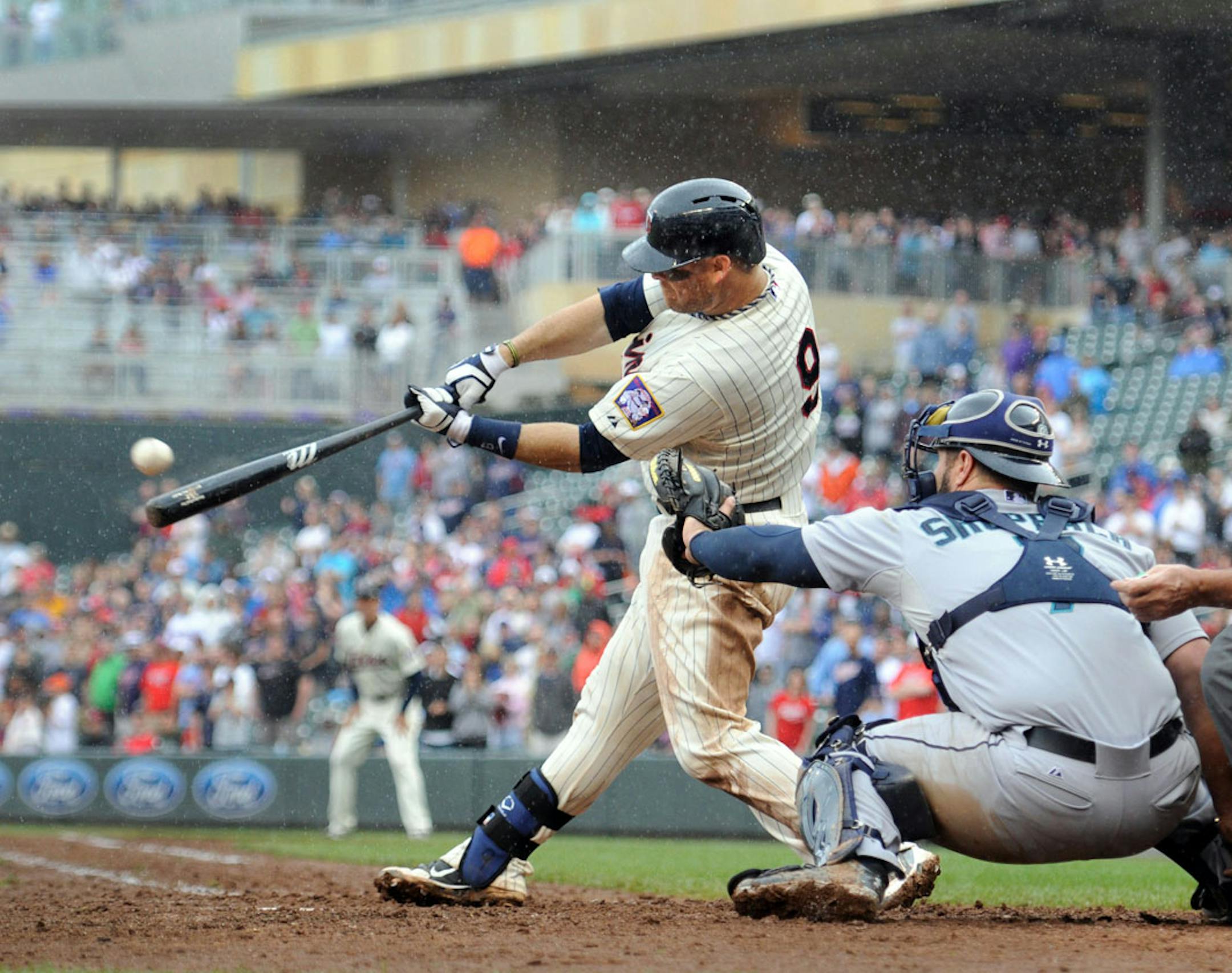 Minnesota Twins catcher Ryan Doumit hits an two-run RBI triple driving in the game-wining runs