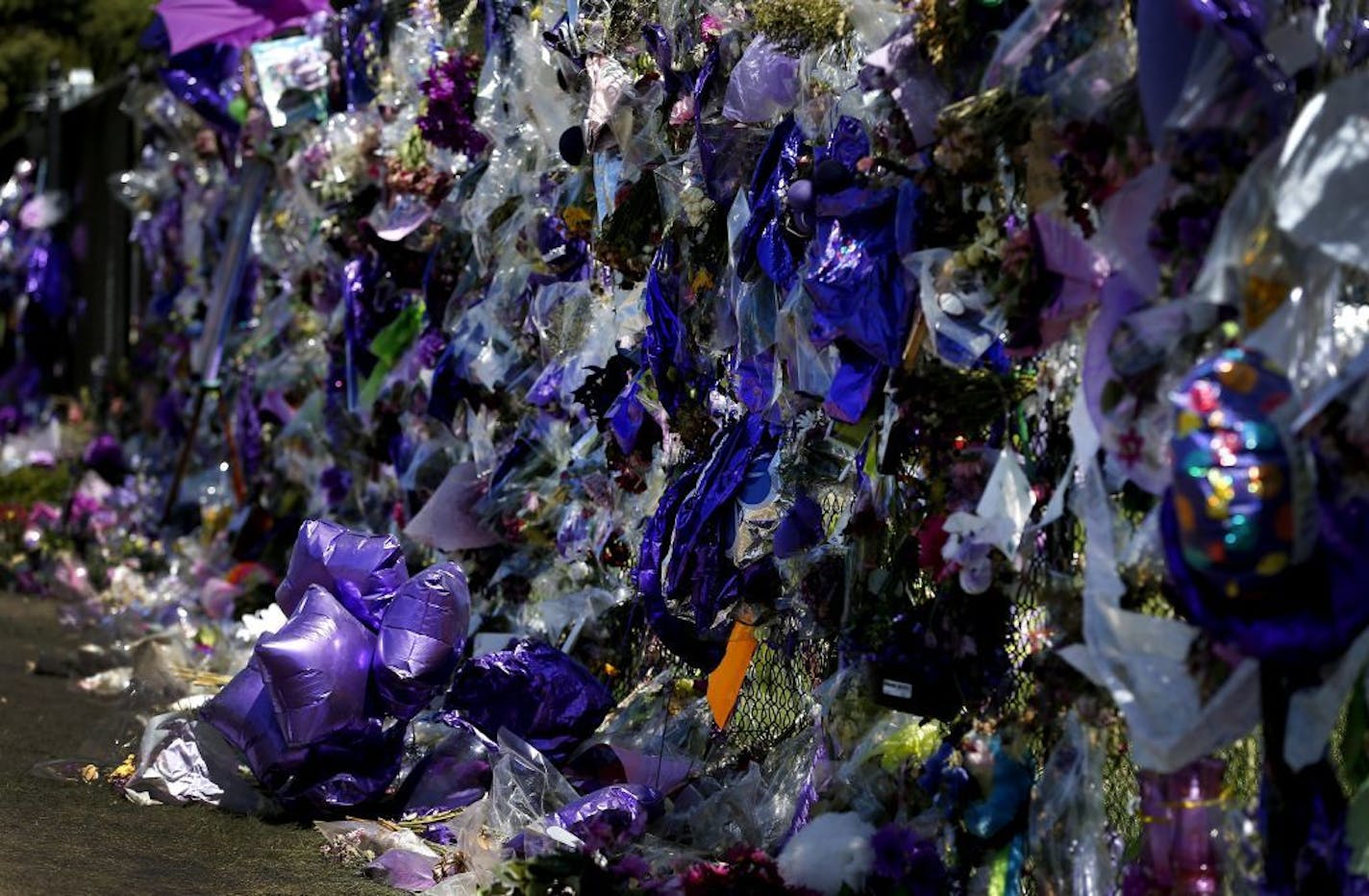 Balloons, flowers and other mementos on the fence surrounding Paisley Park in Chanhassen recently mourned the loss of Prince.