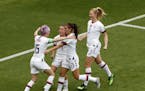 United States' Megan Rapinoe, left, celebrates with teammates after scoring her side's first goal from the penalty spot during the Women's World Cup r
