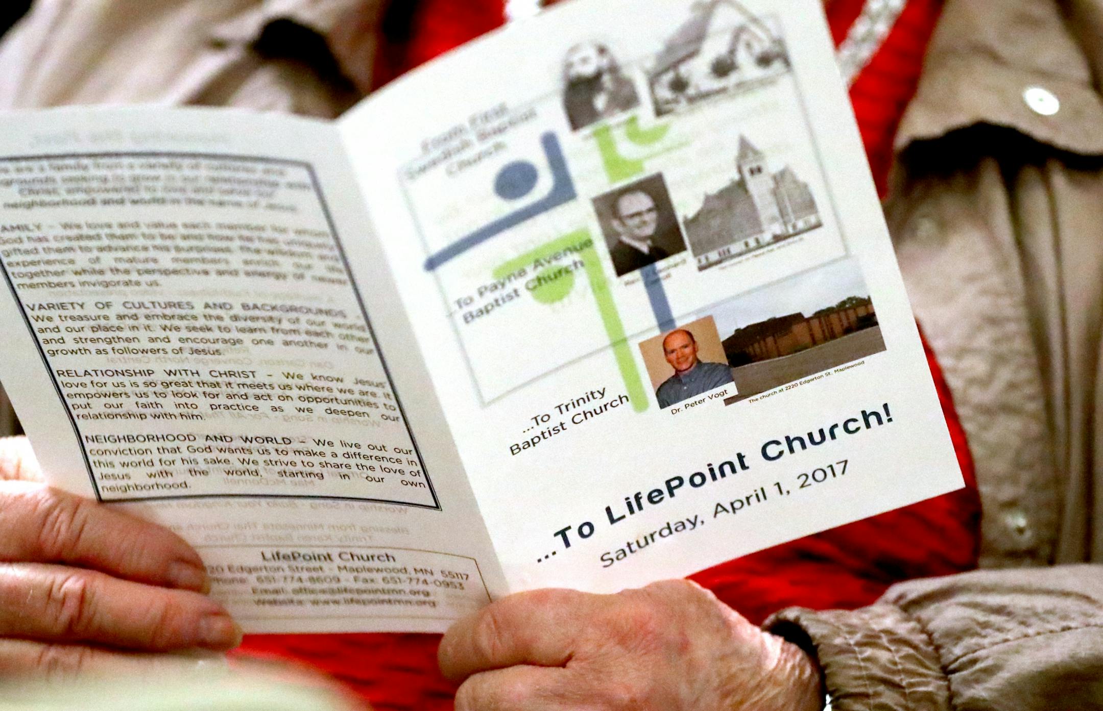 A church member holds the program for a ceremony entitled: Honoring the Past, Preparing for the Future: Trinity Baptist Church becomes LifePoint Church Saturday, April 1, 2017, in St. Paul, MN.