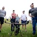 Minnesota Drone Day attendees, standing around an M-600 Pro drone, looked up to the sky during an RC helicopter demonstration Saturday at Black Hawk M