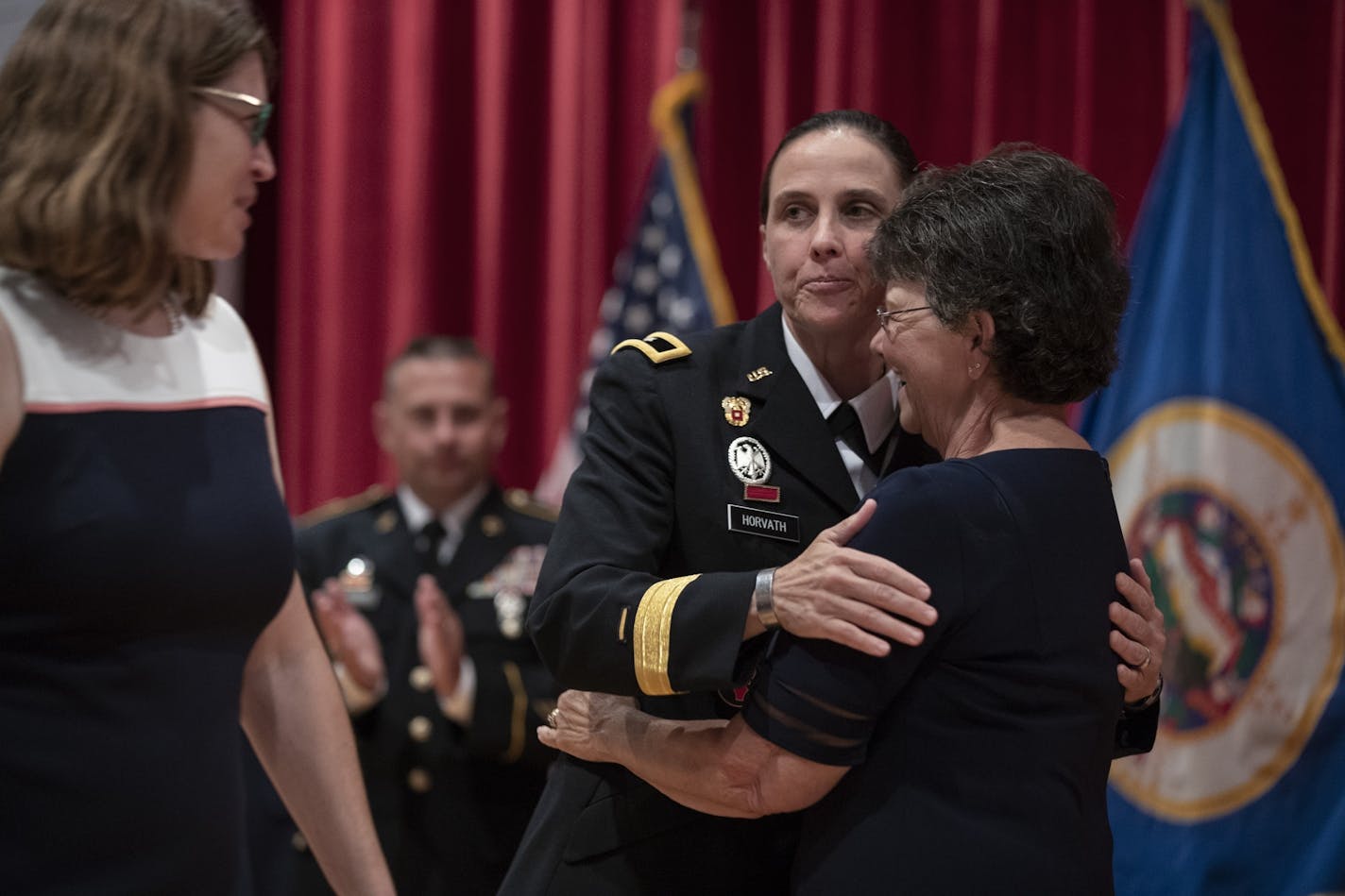 Brigadier General Stefanie Horvath embraced her mother Catherine Horvath as her wife Christy Starks looked on during a promotion ceremony Tuesday July,9 2019 in Rosemount, MN.