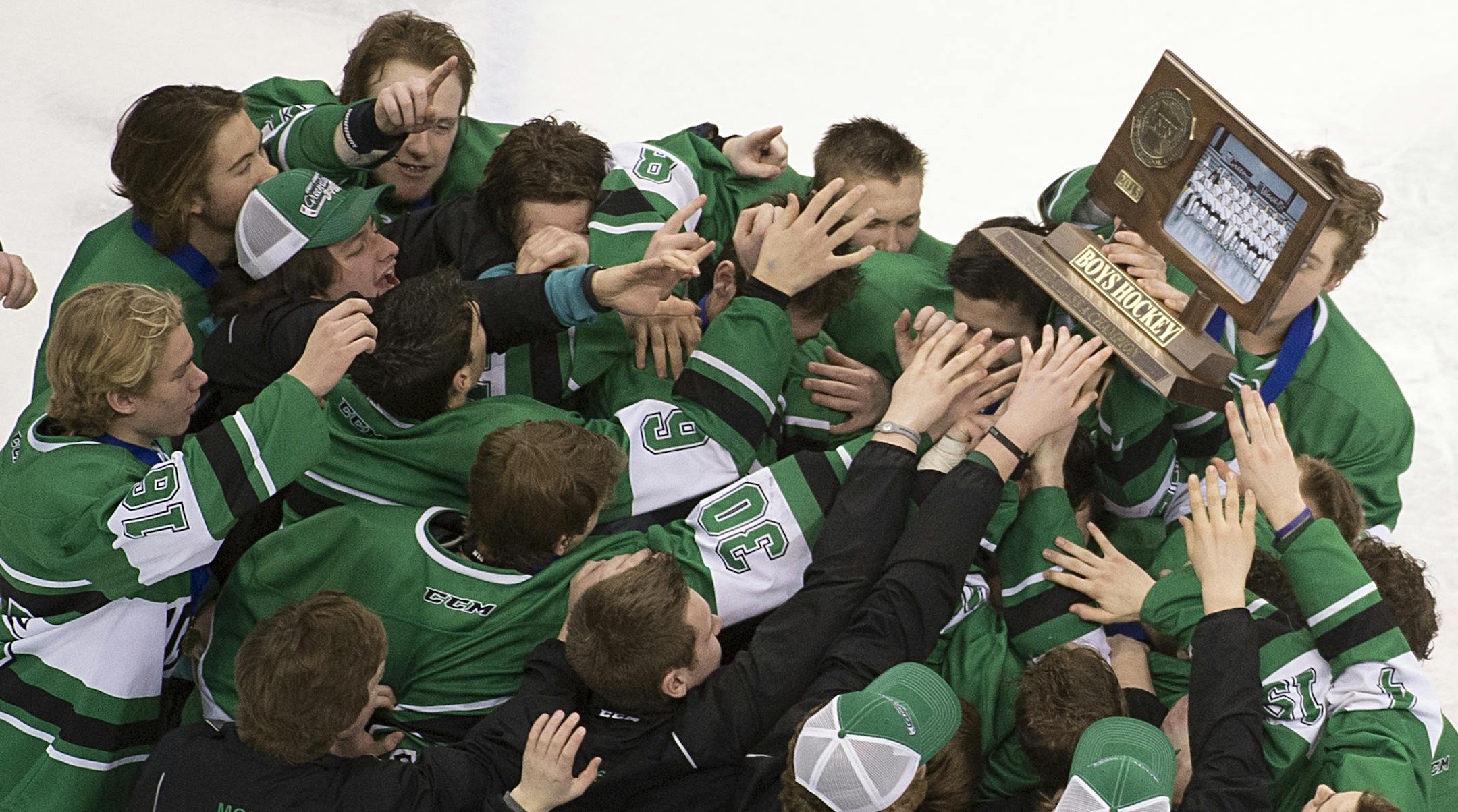 East Grand Forks players hoist their championship trophy above their heads after defeating Hermantown 5-4 in overtime. ] (Aaron Lavinsky | StarTribune) Hermantown plays East Grand Forks in the Class 1A boys' hockey state championship game on Saturday, March 7, 2015 at Xcel Energy Center.