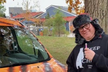 Ashley Verdeck, an education specialist at the Como Zoo, is the star in a viral video created by the zoo that features its tiger van.