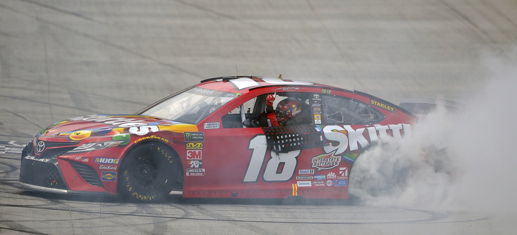 Kyle Busch does a burnout after winning the NASCAR Cup Series auto race Sunday, April 7, 2019, at Bristol Motor Speedway in Bristol, Tenn. (Andre Teague/Bristol Herald Courier via AP)