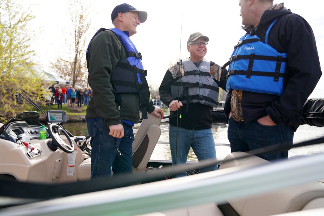 Gov. Tim Walz talked with GOP Senate Majority Leader Sen. Paul Gazelka, left, and his chief of staff Chris Schmitter as they boarded a boat for the Governor’s Fishing Opener in 2019.