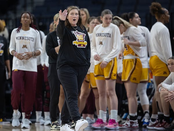 Lindsay Whalen with players during her final game as Gophers coach on Wednesday vs. Penn State. She agreed to resign Thursday.