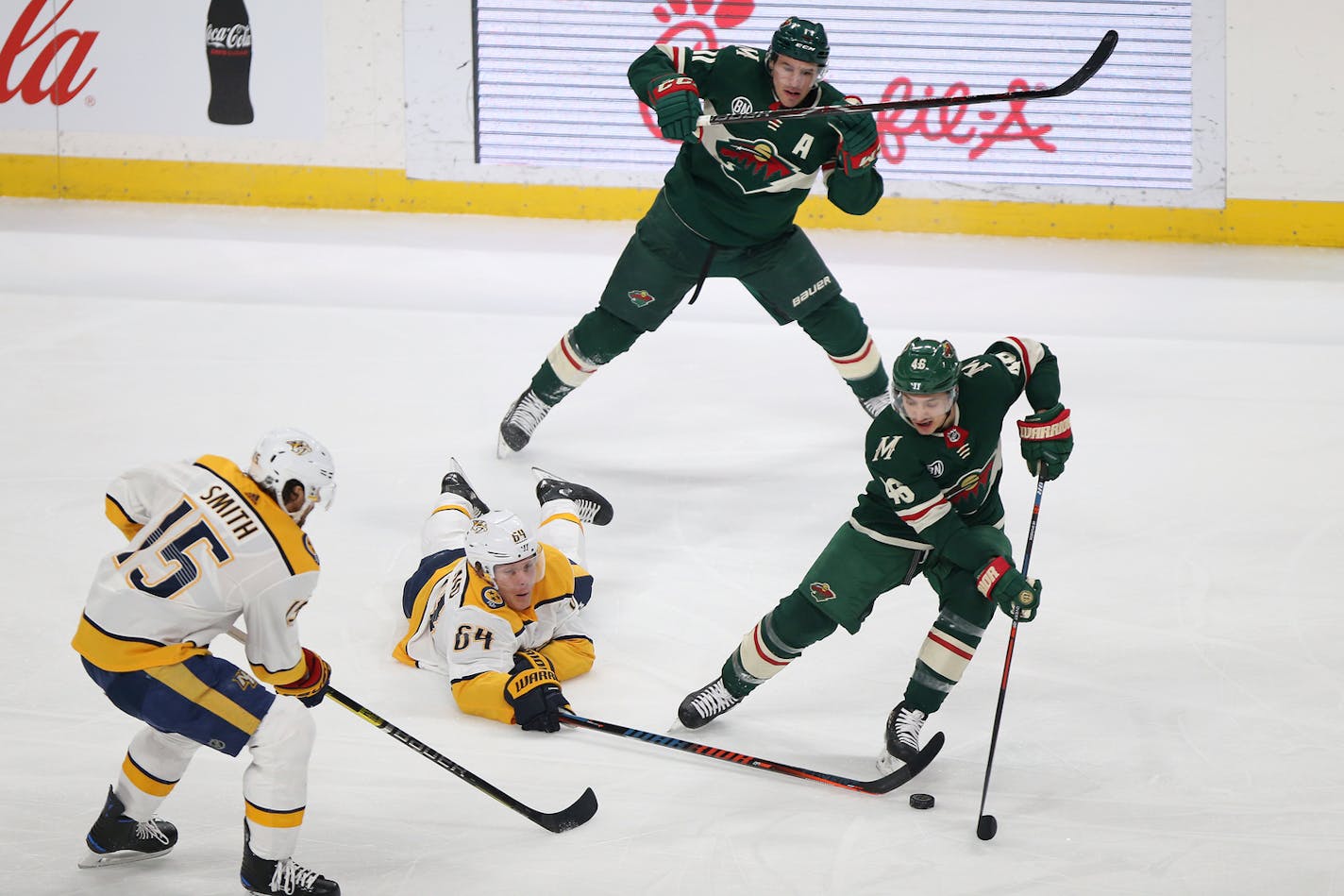 The Wild's Jared Spurgeon and the Predators' Mikael Granlund went after the puck during the first period Sunday. Nashville won 3-2 in a shootout, ending the Wild's five-game winning streak.