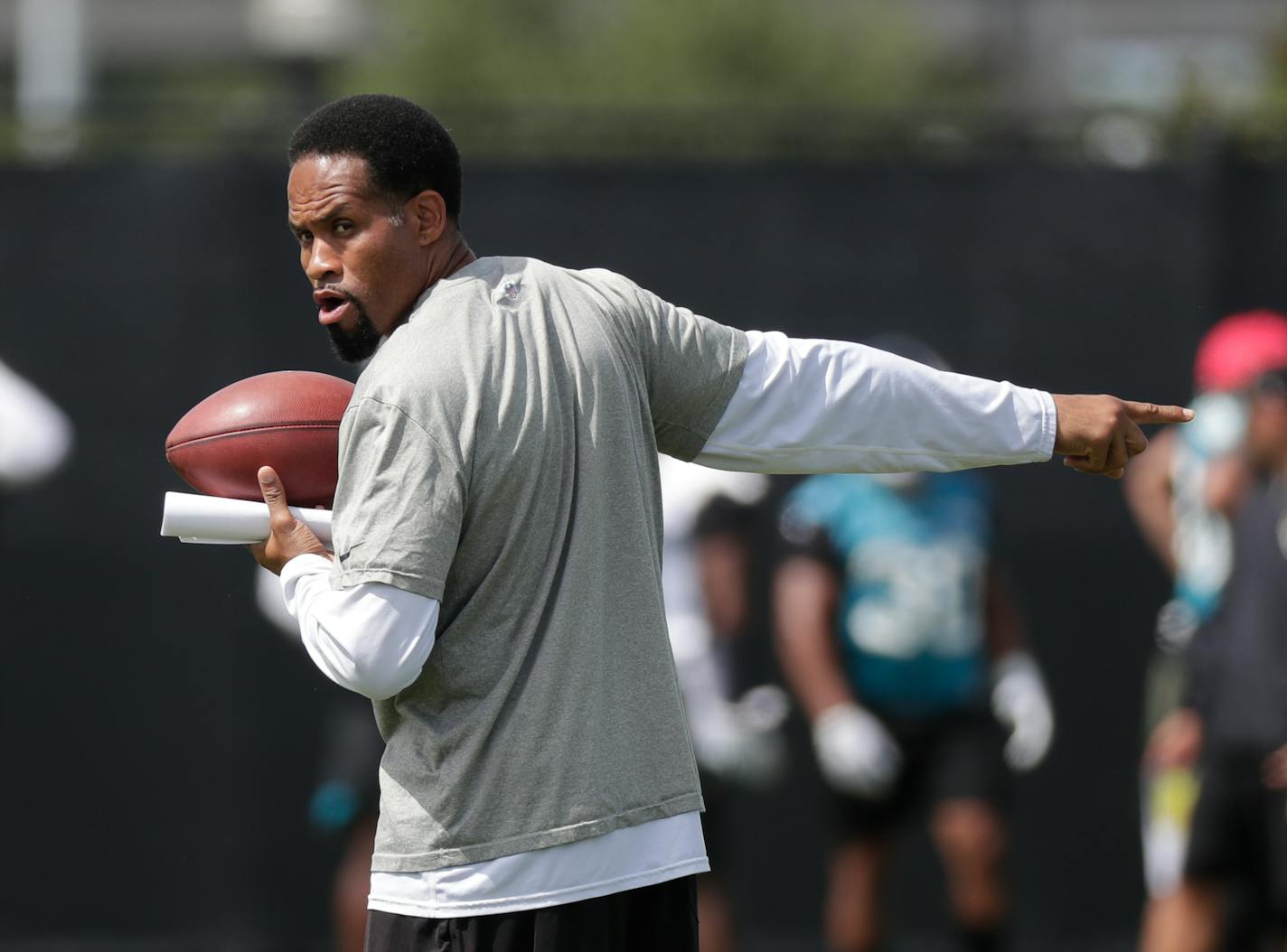 Jacksonville Jaguars wide receivers coach Keenan McCardell directs players during an NFL football practice Friday, May 25, 2018, in Jacksonville, Fla. (AP Photo/John Raoux)